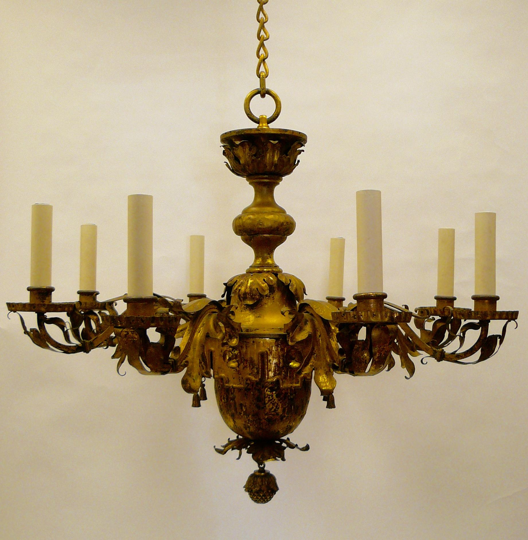 Attributed to E. F. Caldwell, the handmade early Georgian style fixture features foliate arms with a lambrequin and tassel decorated central urn form body.