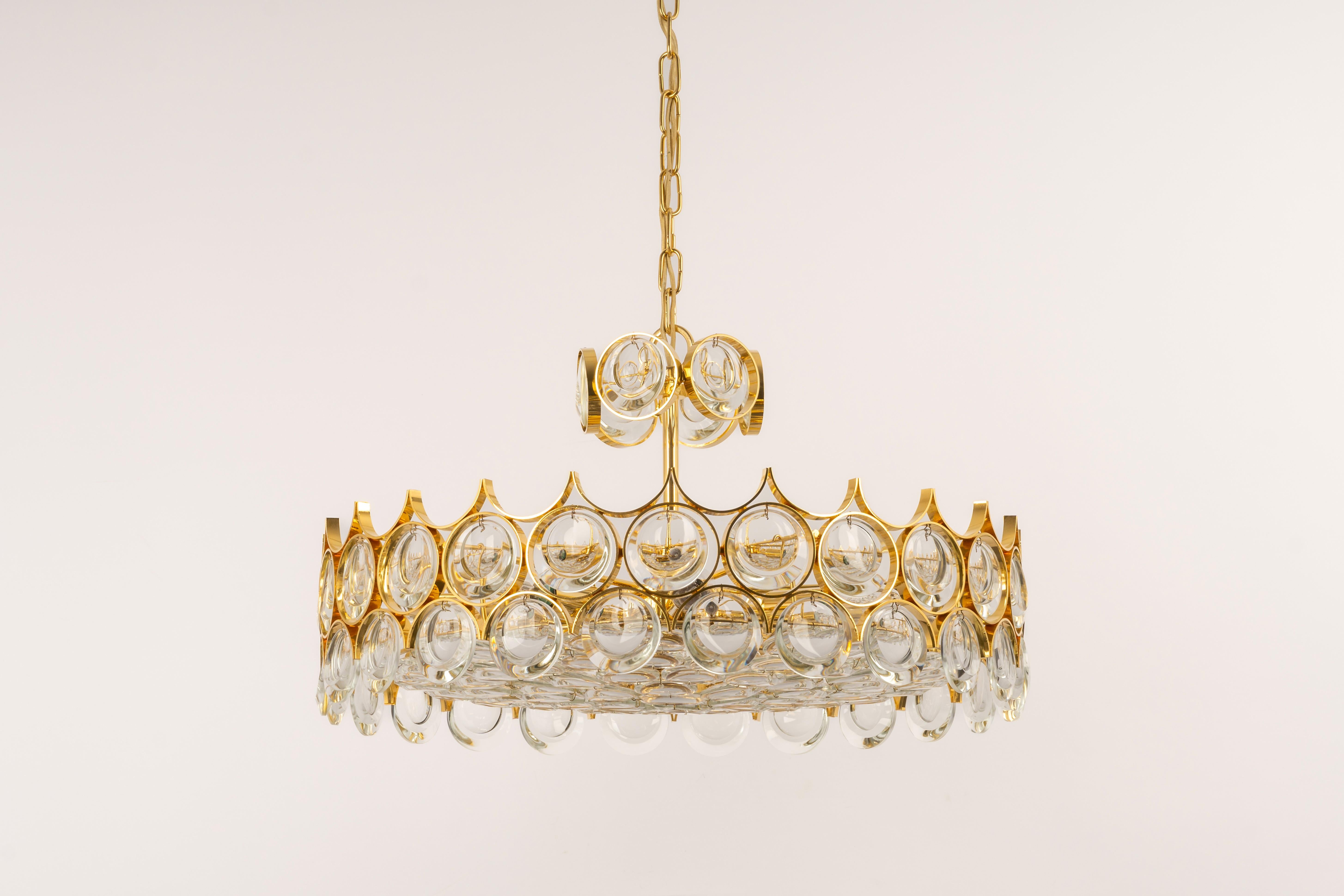A wonderful and high-quality gilded chandelier or pendant light fixture by Palwa -Design Sciolari, Germany, 1970s.
It is made of a 24-carat gold-plated brass frame decorated with individual 