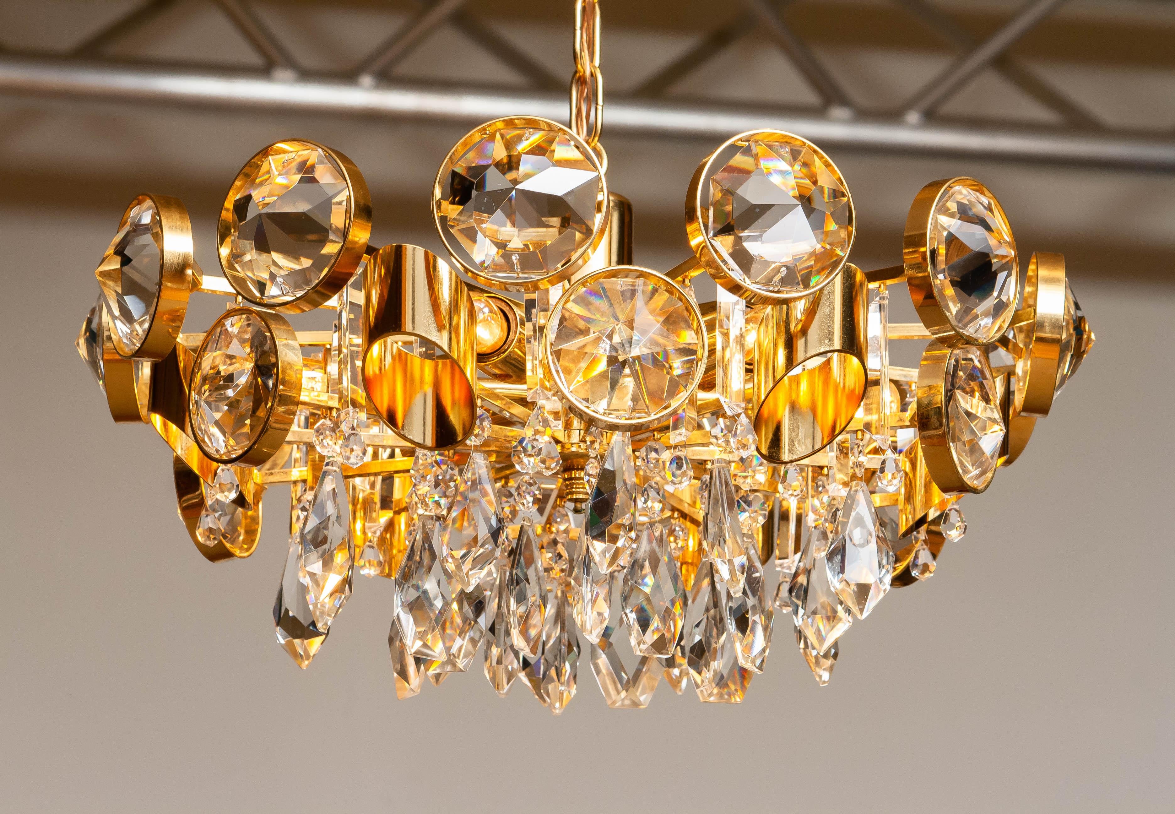 Hollywood Regency Large Gilt Brass Filled with Large Faceted Crystals Chandelier by Ernest Palme For Sale