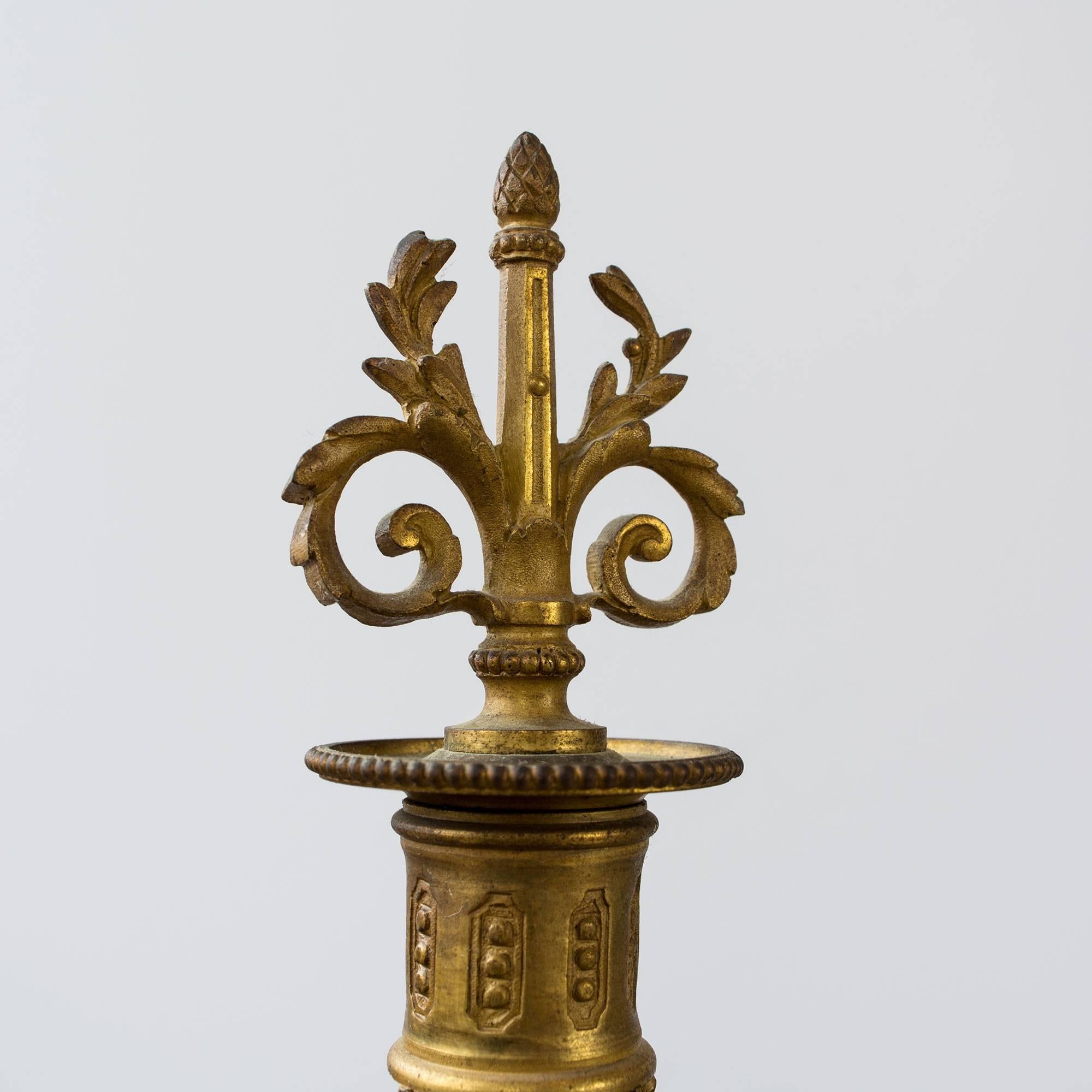 From the 19th century, a fabulous pair of six-arm with centre candle candelabra in Louis XVI style. Each arm adorned with beautifully detailed branches, acanthus leafs and aplenty of scrolls. There is a center urn adorned with bold lion faces,