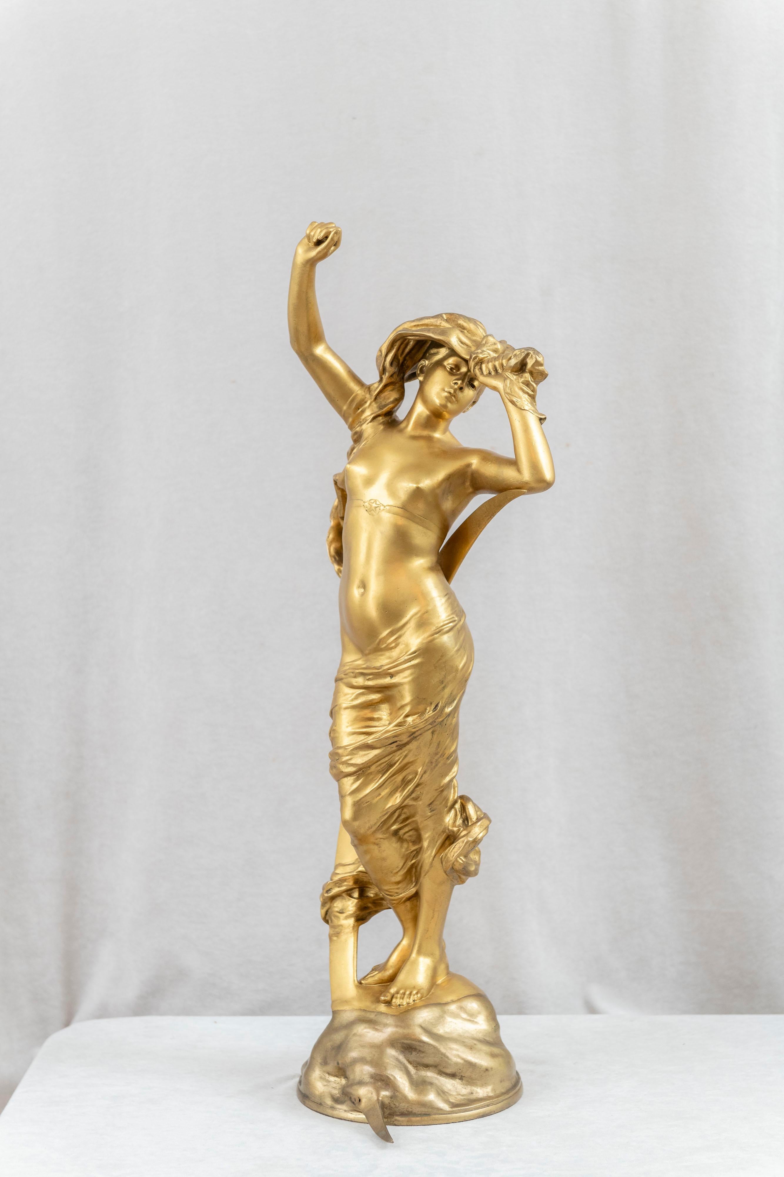 This large and sexy gilt bronze figure of a scantily clad maiden is a great example of the art nouveau movement. Titled 