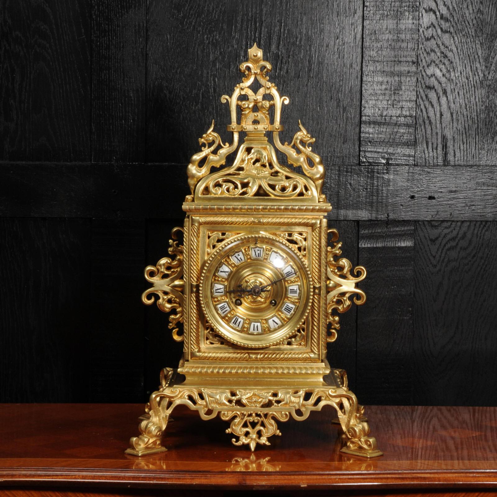 A large and stunning antique French Baroque table clock by Samuel Marti, circa 1880. The clock is elaborately decorated in a nautical theme. The base is pieced with wave forms with stylised dolphins as feet to each corner. The bell shaped top