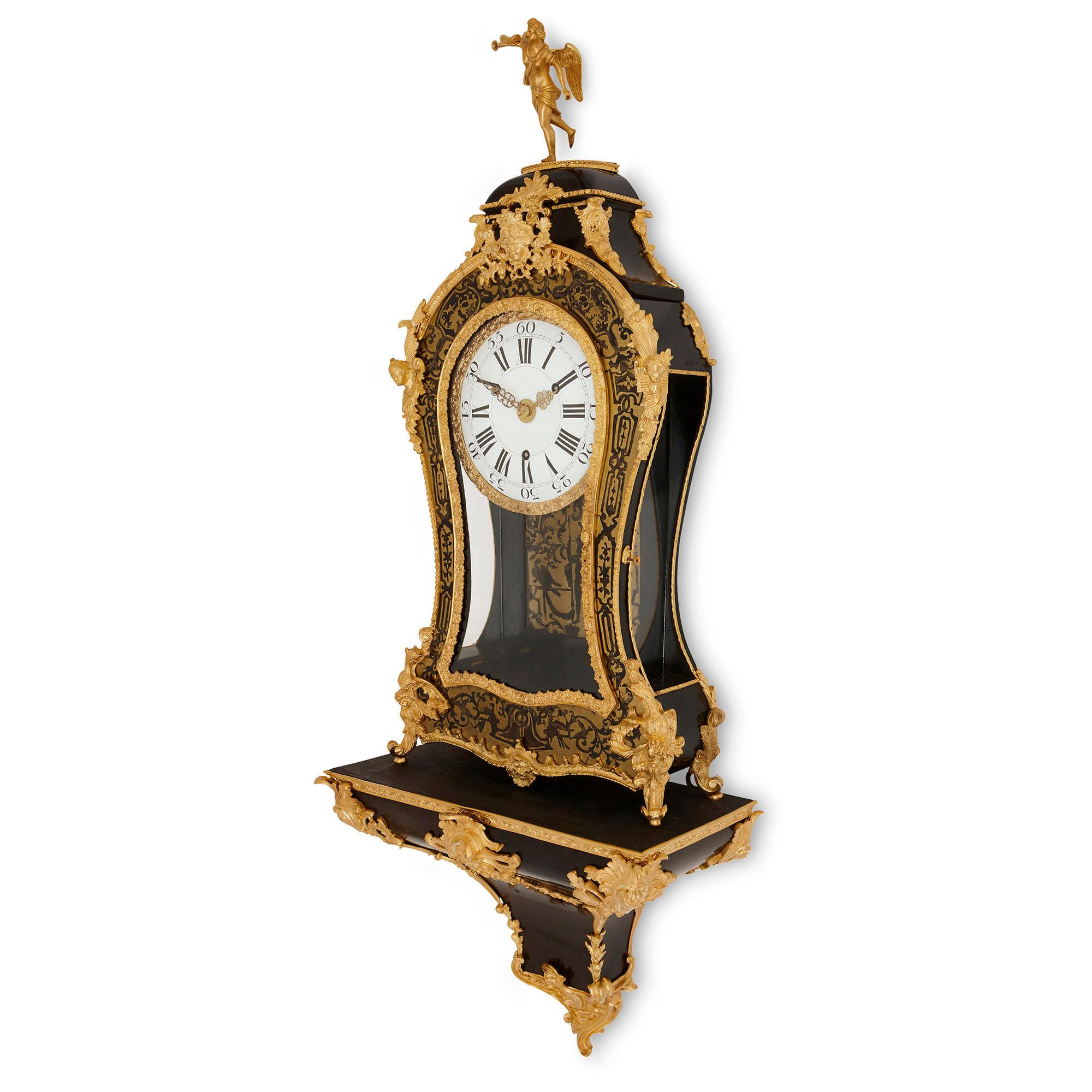This Boulle wall clock is comprised of two components: the clock body and the bracket upon which the clock body sits. The wooden clock case is violin shaped and, where not decorated with brass inlayed with tortoiseshell, this wood has been ebonised.