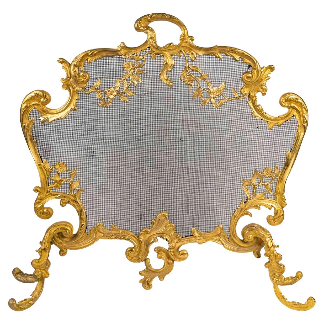 Grand pare-feu en bronze doré de style Louis XV.