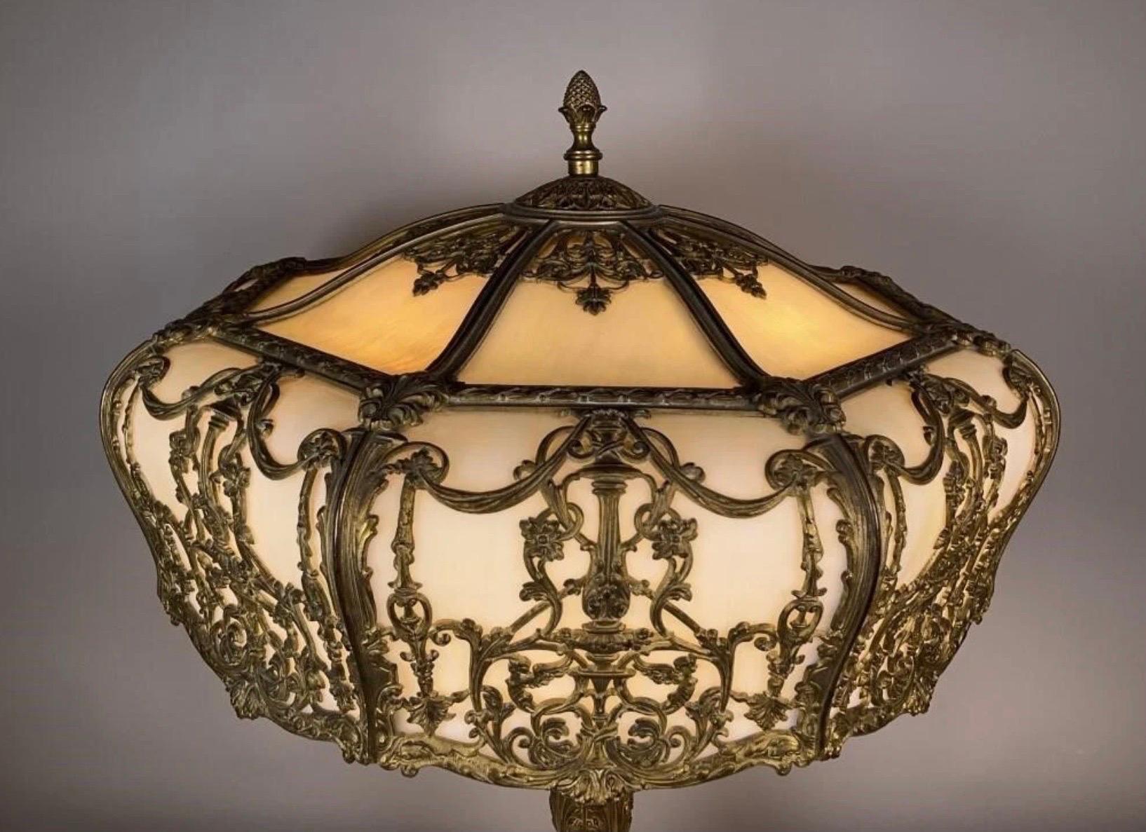 A large gilt bronze and bent glass table lamp, 24 inch diameter shade with original matching base. The glass is a pearly white with a bronze frame and base. Exceptional Quality, either Bradly and Hubbard or E.F. Caldwell. Rewired with 2 new sockets.