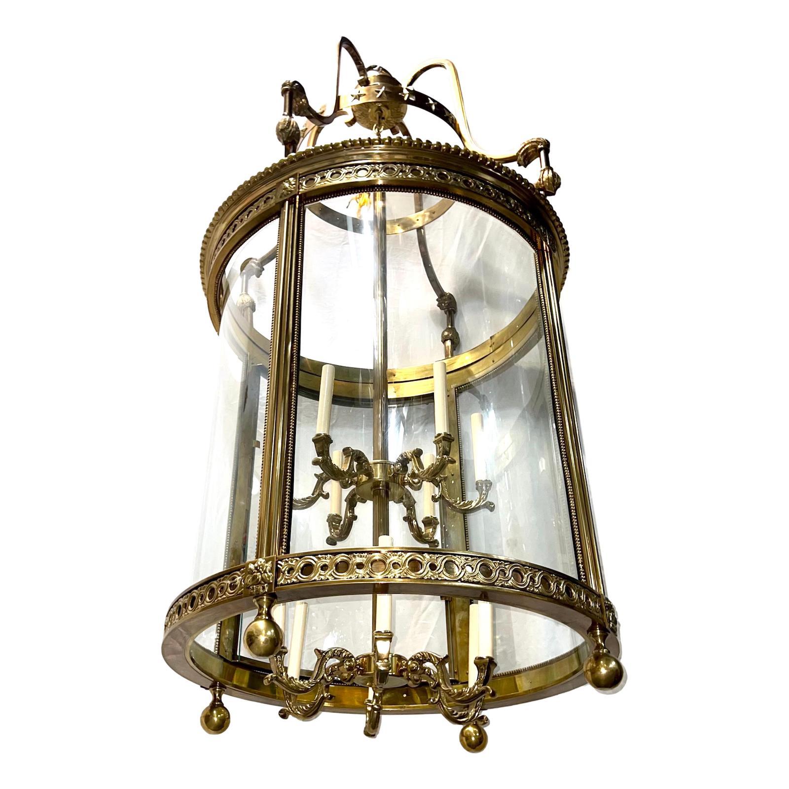 A circa 1930's French Neoclassic style gilt bronze lantern with double interior cluster. The body has detailed cast beading and tassel work and bent glass insets.

Measurements
Height of body: 62