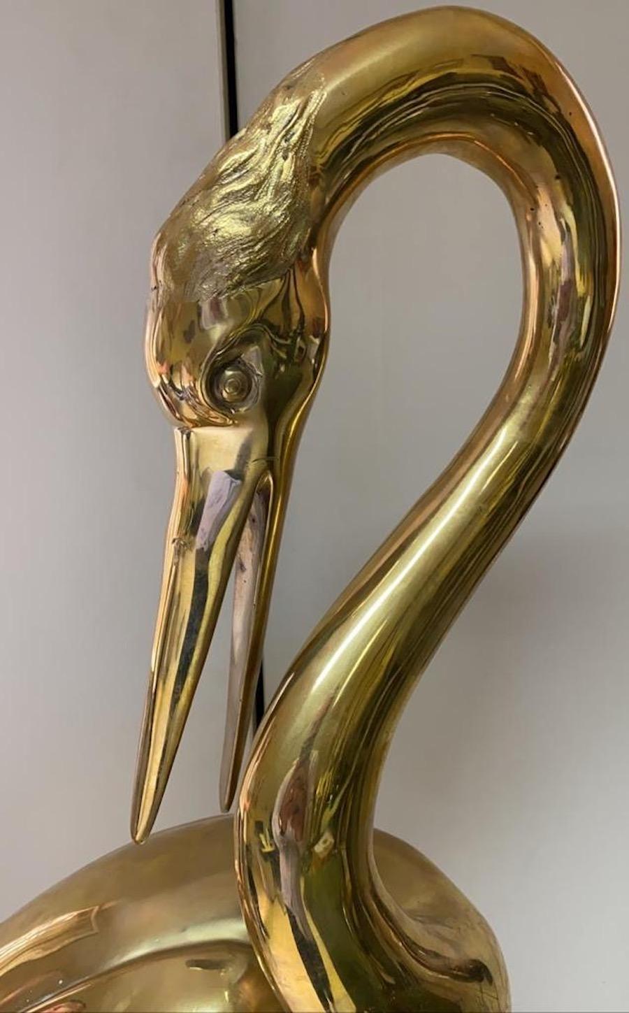 Elegant pair of gilt bronze heron sculptures. The item will be well-suited to either an indoor or outdoor setting.