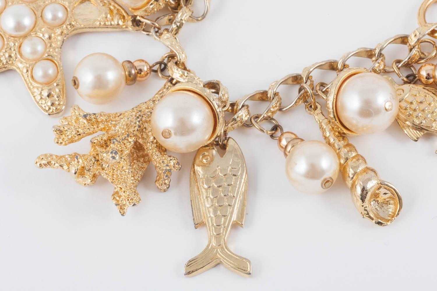 Women's Large gilt metal and paste pearl 'seashell' charm bracelet, USA, 1960s