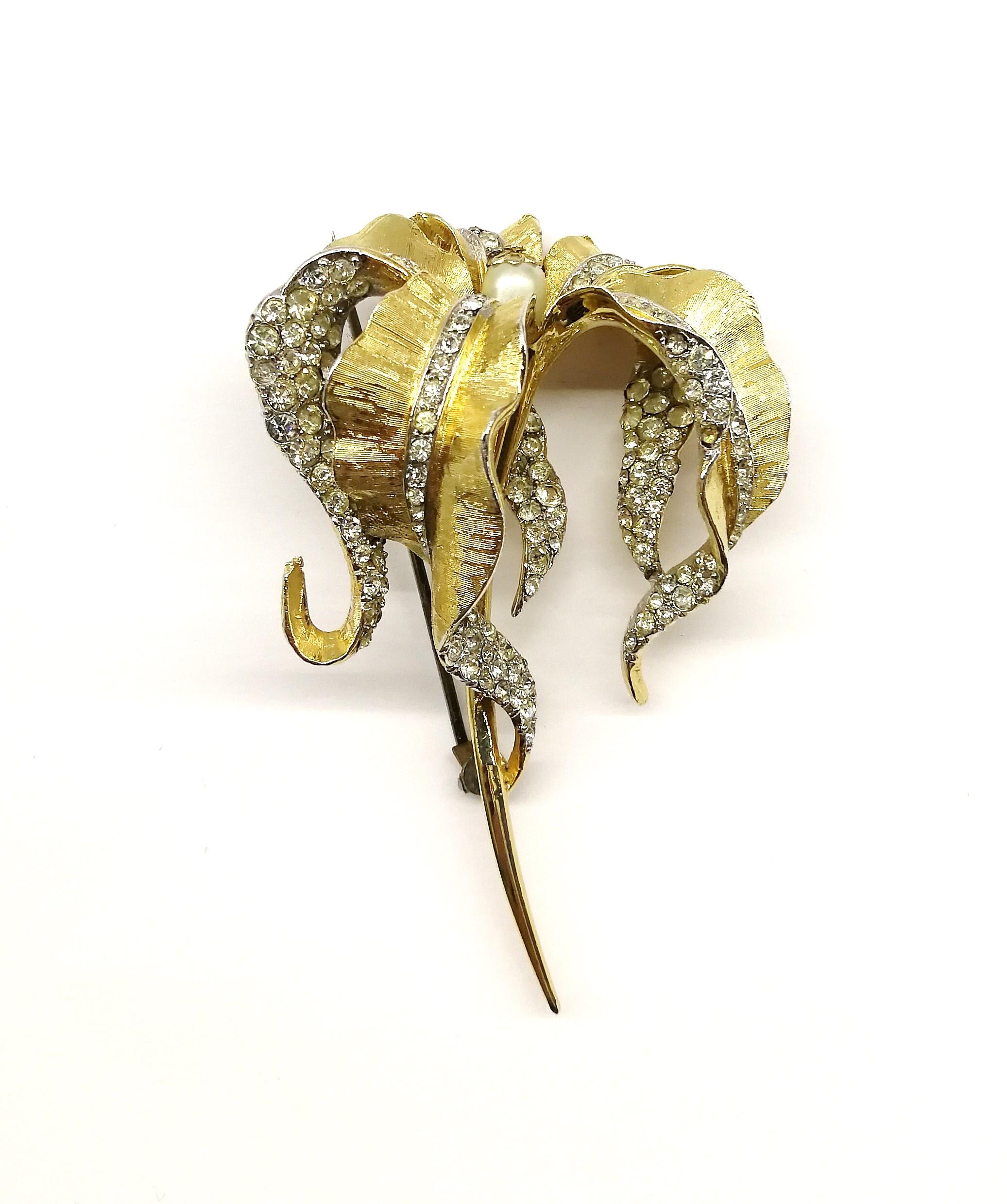 A stylish and striking 'lily' brooch, of the standard and quality as expected from Boucher jewellery, made in the 1960s, in the manner of Van Cleef and Arpels jewellery of the period.
Marcel Boucher manufactured costume jewellery from 1937 through