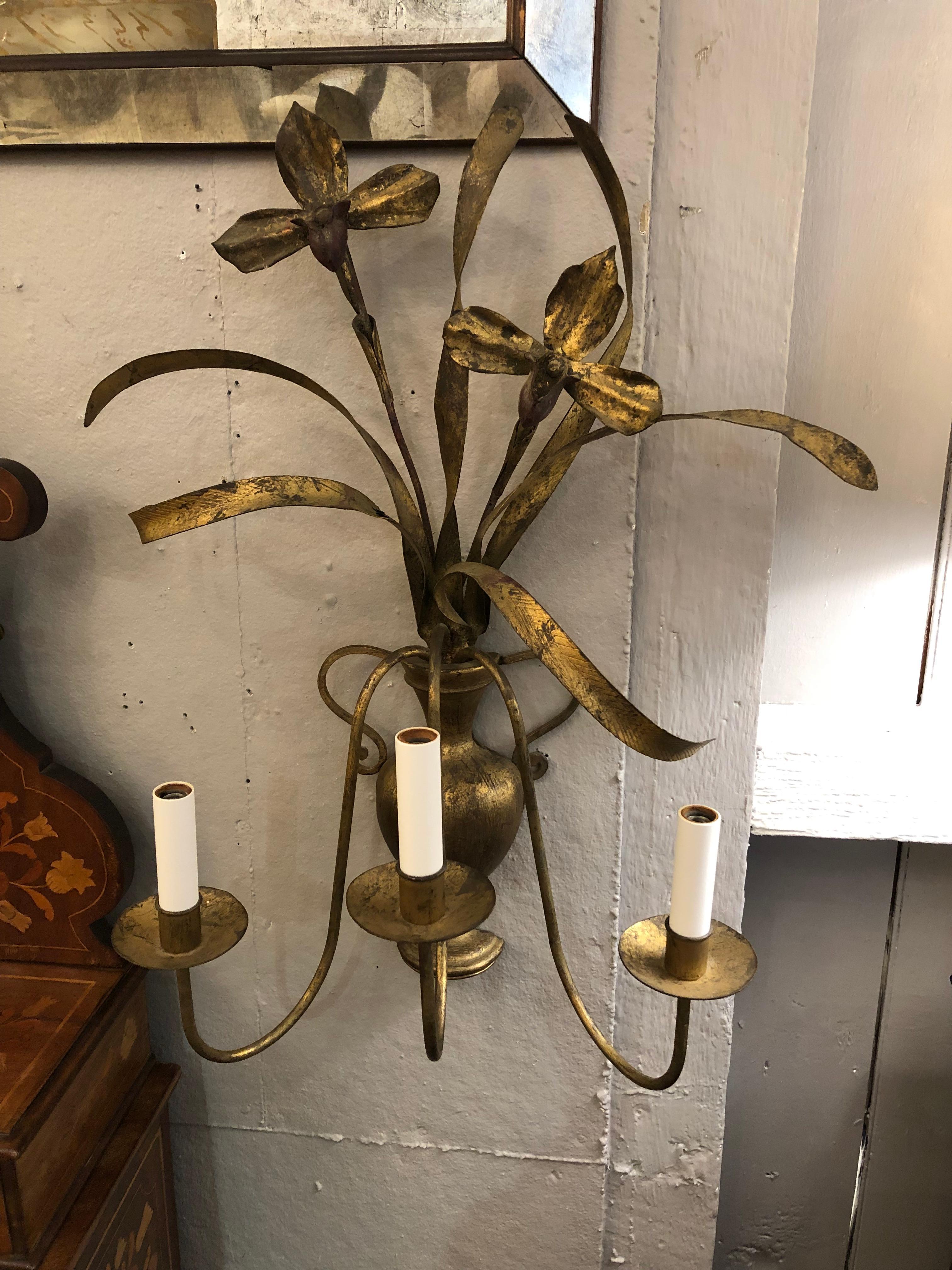Lovely & large pair of Italian gilt metal electrified wall sconces having urns with iris arrangements and 3 curved candelabra arms.