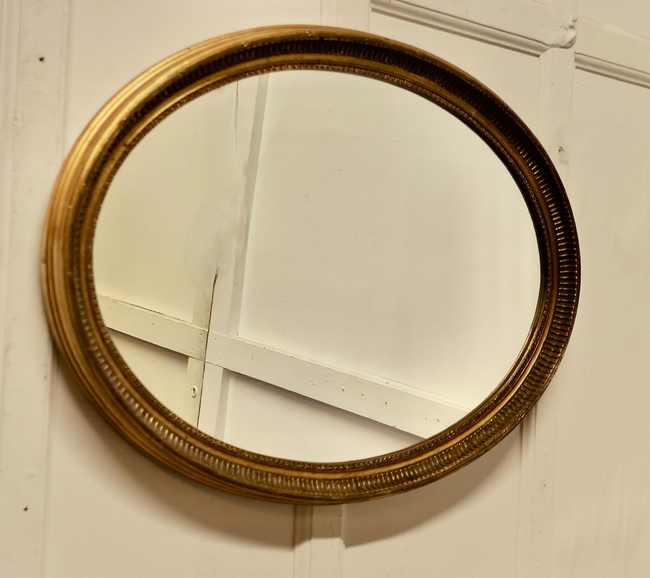Large Gilt Oval Mirror

This Mirror has a 2” wide deeply moulded oval frame, this has a good gilt finish
The Oval frame is in attractive condition as is the looking glass
The mirror is 33” wide and 23” tall 
SC214