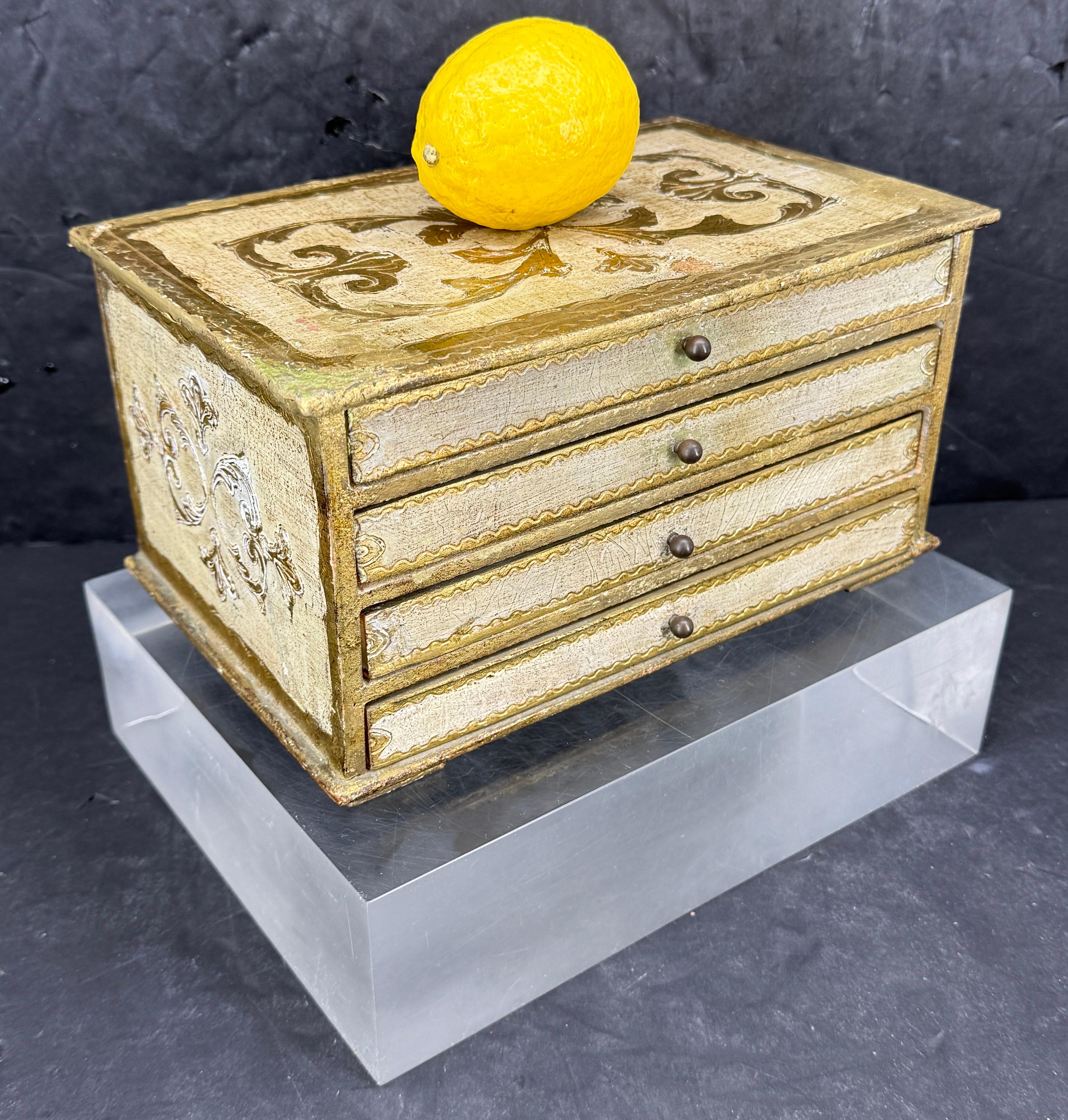 Italian Florentine Jewelry Box or Miniature Chest of Drawers. This 1950's vintage gilt wood piece with four drawers and many compartments has lots of character and patina. Wonderful piece to add to a collection or start a new one.