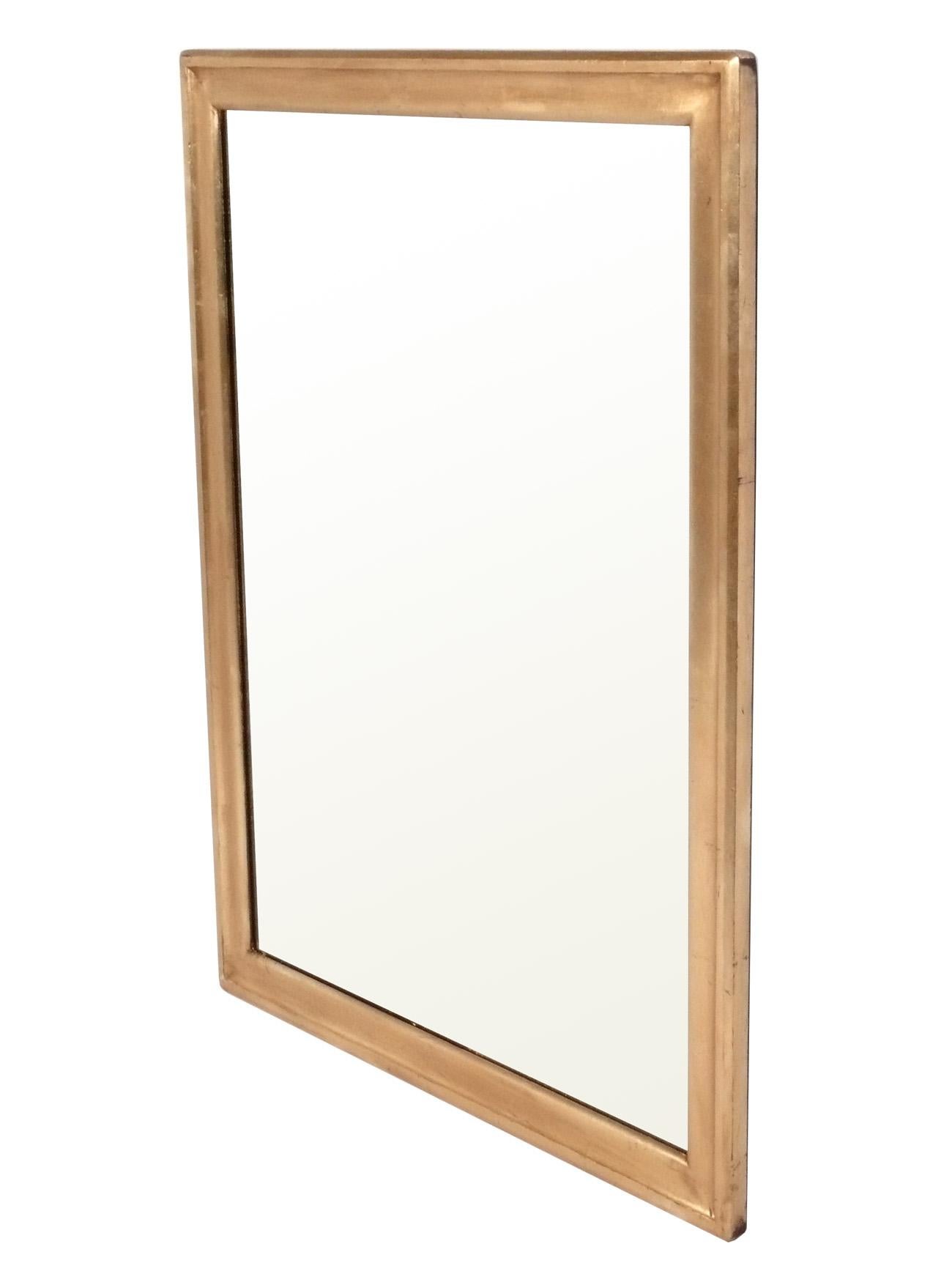 Grand miroir en bois doré, américain, vers les années 1950. Il mesure 44,75 