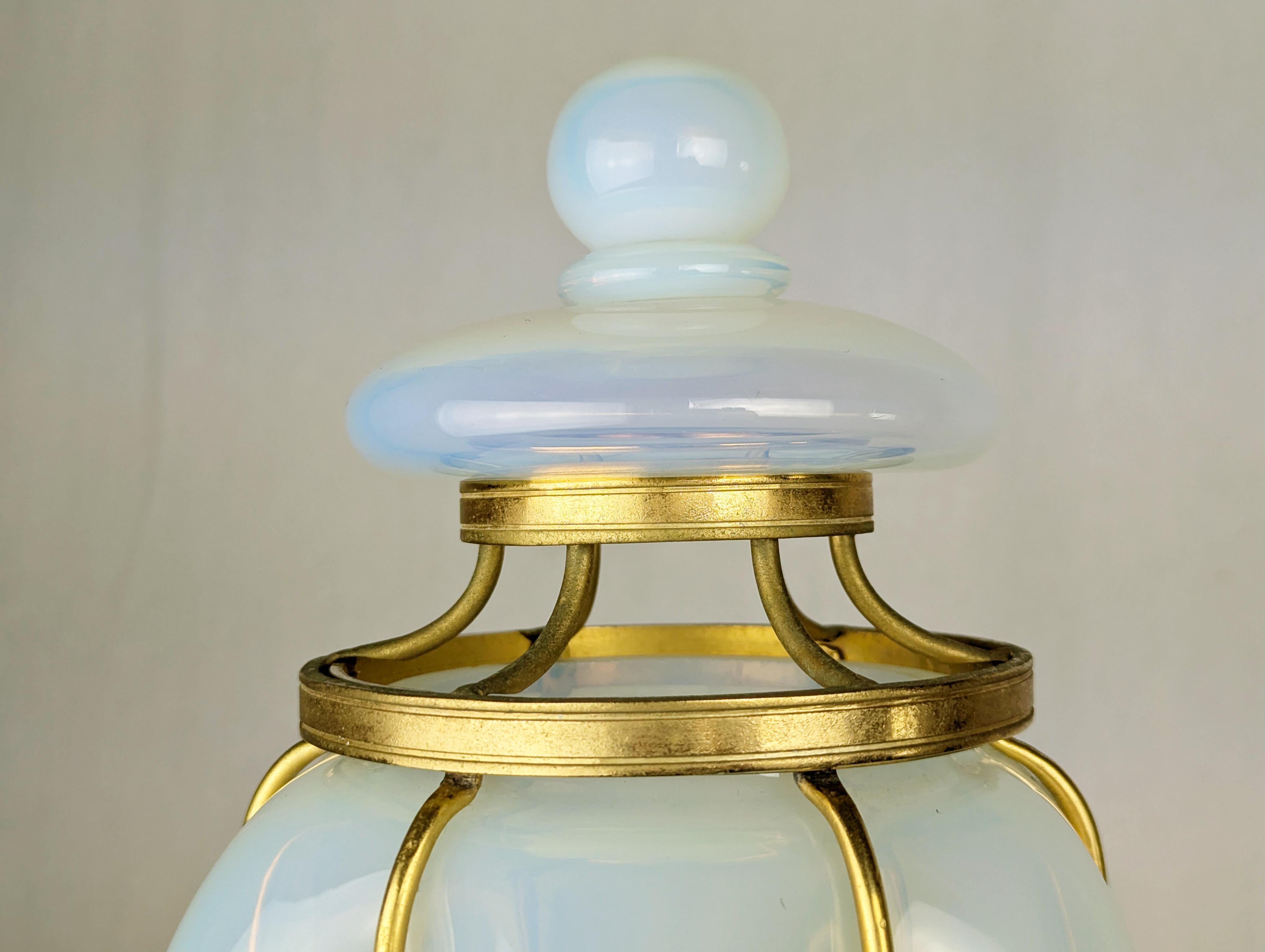 Rare and important iridescent Murano glass & gilted metal sconce manufactured in Murano around the 1940s. This large sconce ( cm 40,5 height) is composed by 3 separated parts: the main body with glass shade, the upper metal grid and the Murano glass