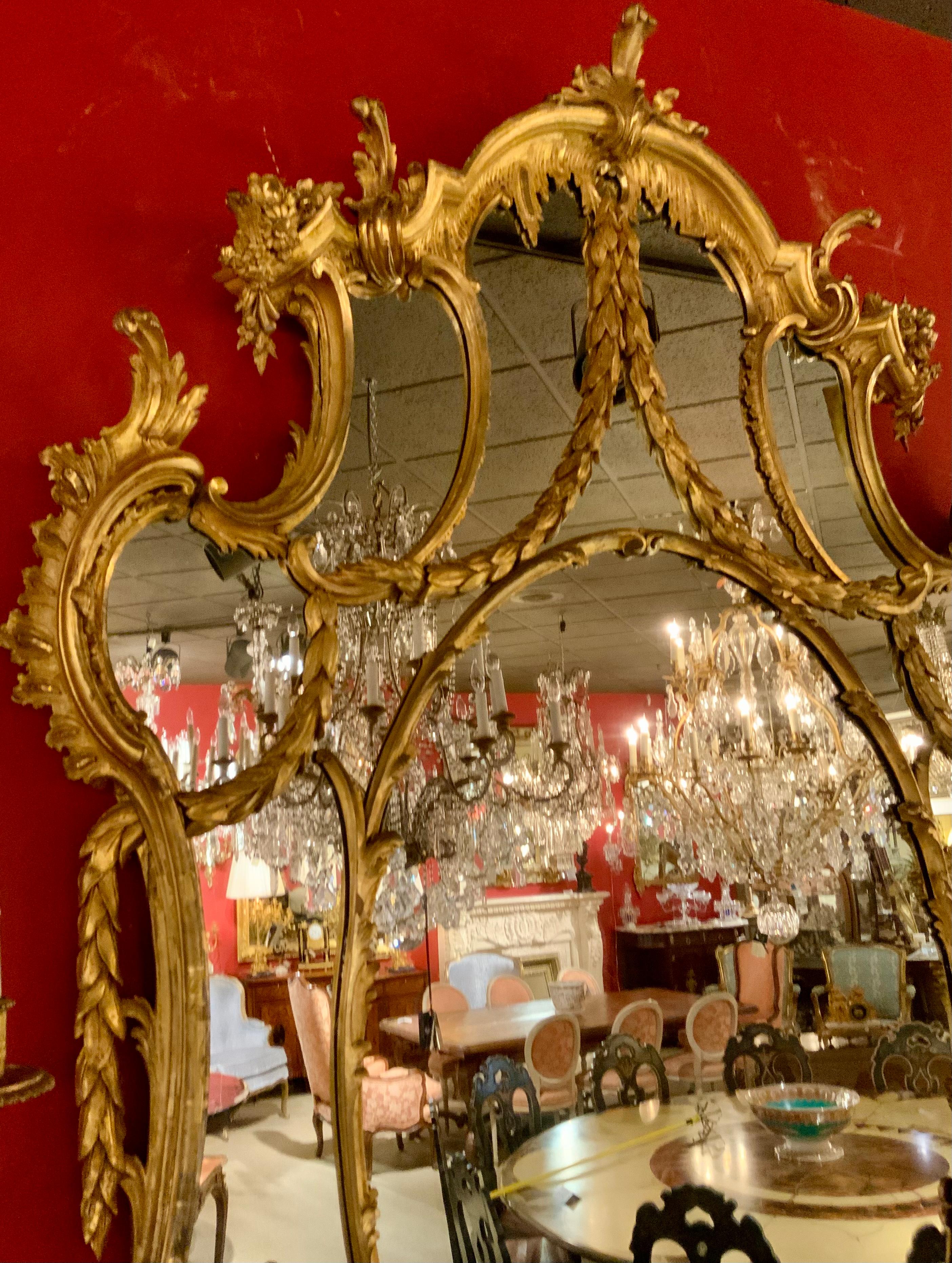 This monumental George III-Style Chinese Chippendale mirror
Is unique because the size and quality are rare. It has a fanned
Foliate crest, over shaped frame with scrolled foliate molding
And floral designs, encasing flat mirror plate. The