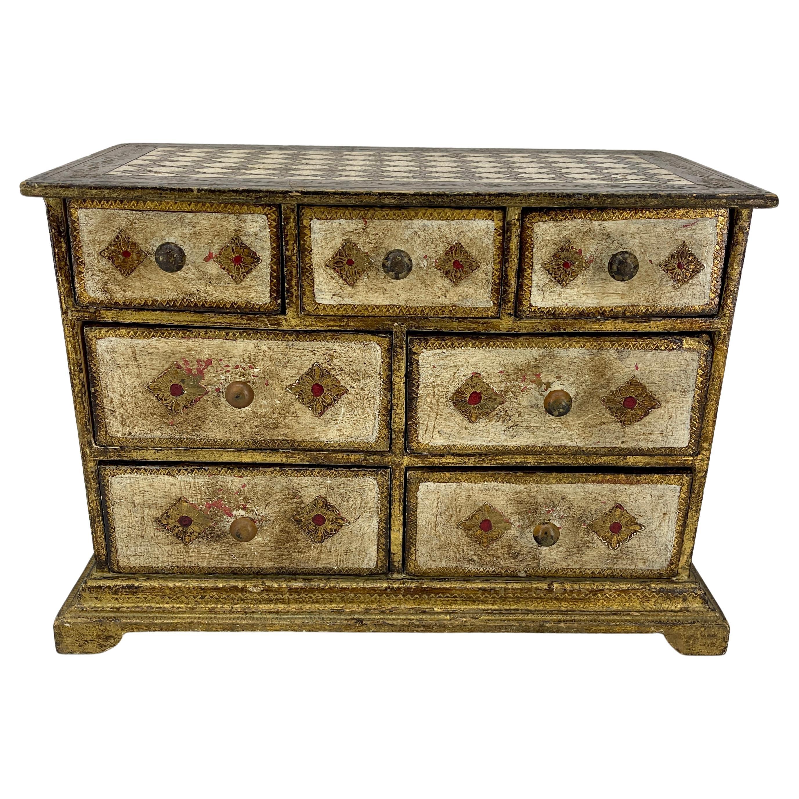 Italian Florentine Jewelry Box or Miniature Chest of Drawers

This 1950's vintage gilt wood piece, lined in velvet with seven drawers has lots of character and patina. Wonderful piece to add to a collection or start a new one.
