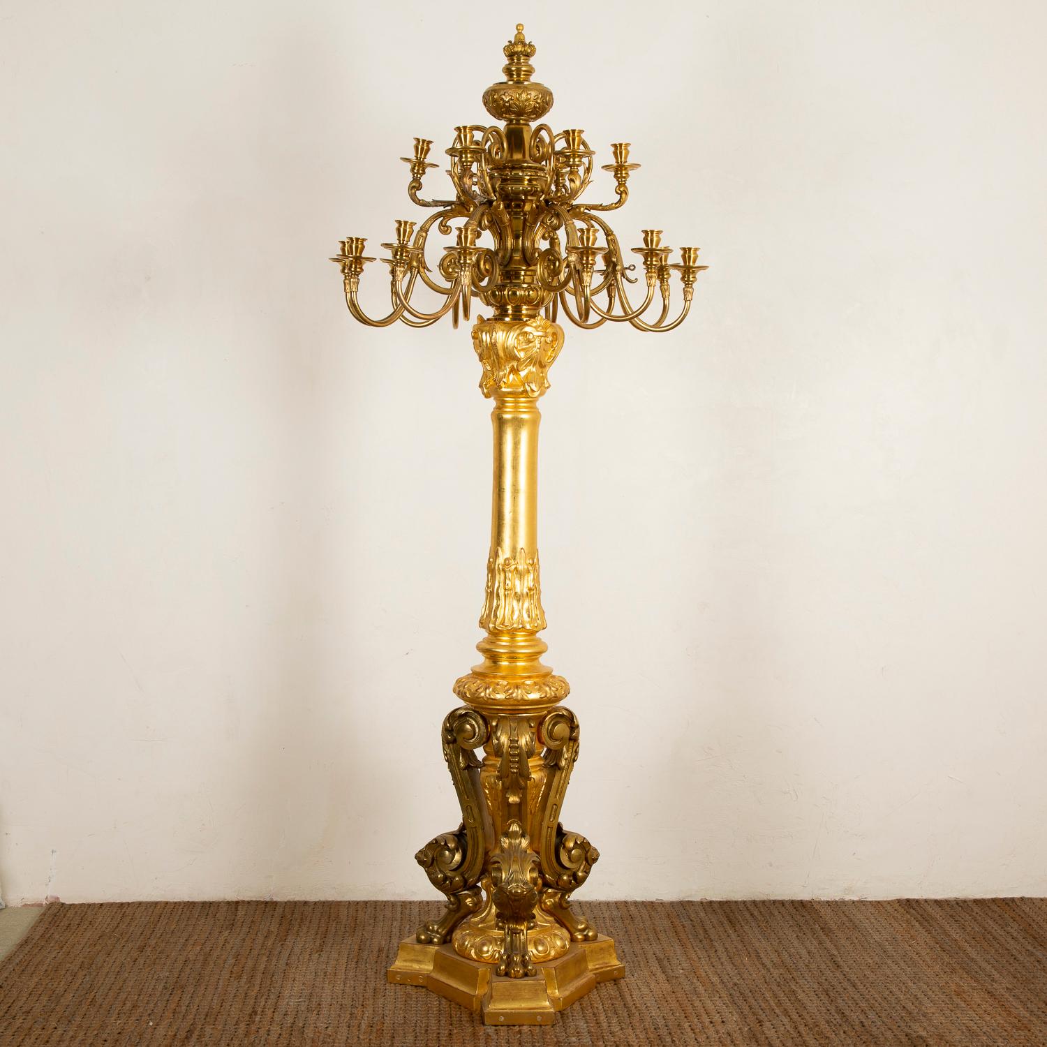 Large giltwood and gilt bronze candelabra in the Louis XVI style, Paris, circa 1870.

Each candelabra has 18 arms, on two tiers.

The candelabra can be wired for use with modern lights, the candle holders have been previously wired for