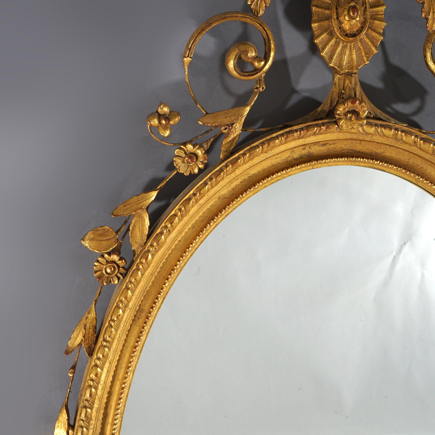 Grande specchio da parete ovale in legno dorato con elementi floreali, fogliame e volute del XX secolo in vendita 1