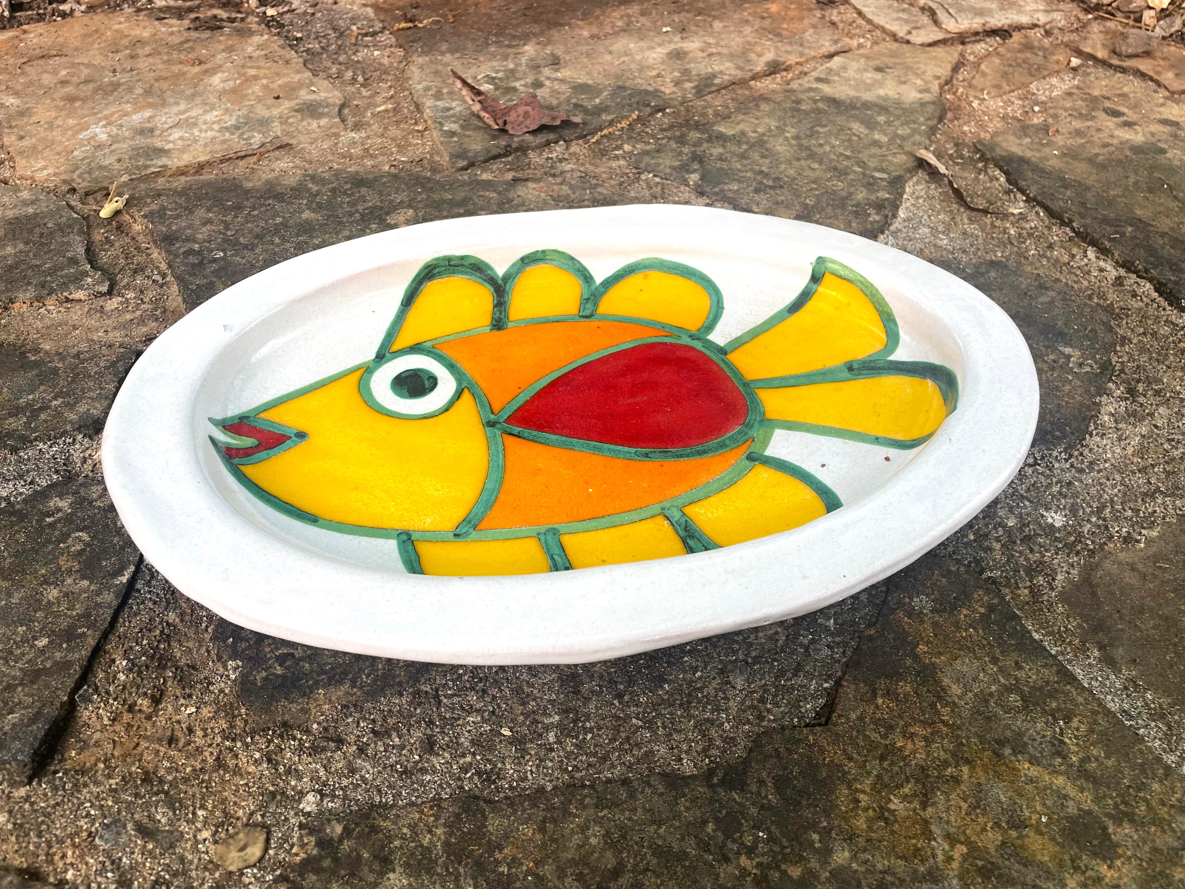 Giovanni Desimone Italian made ceramic platter with hand painted large yellow fish. This particular platter seems to be quite rare.

Giovanni DeSimone (1931-1999) was an Italian ceramic artist known for his vibrant, playful designs. He created