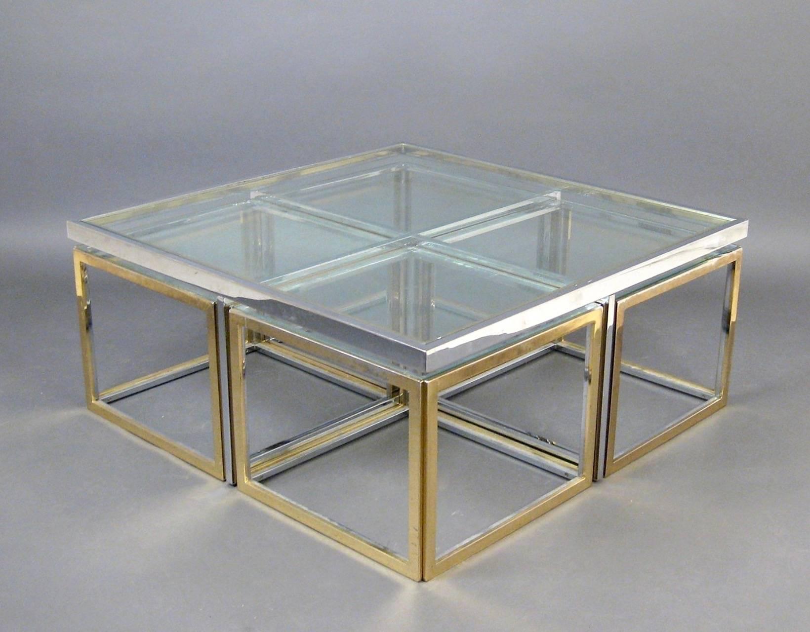 Large coffee table with four small movable tables. Construction of polished chrome and gold-colored metal, loose inset clear glass plate. Attributed to Maison Charles.
The table has been recently restored and re-polished, only minor fading and tiny