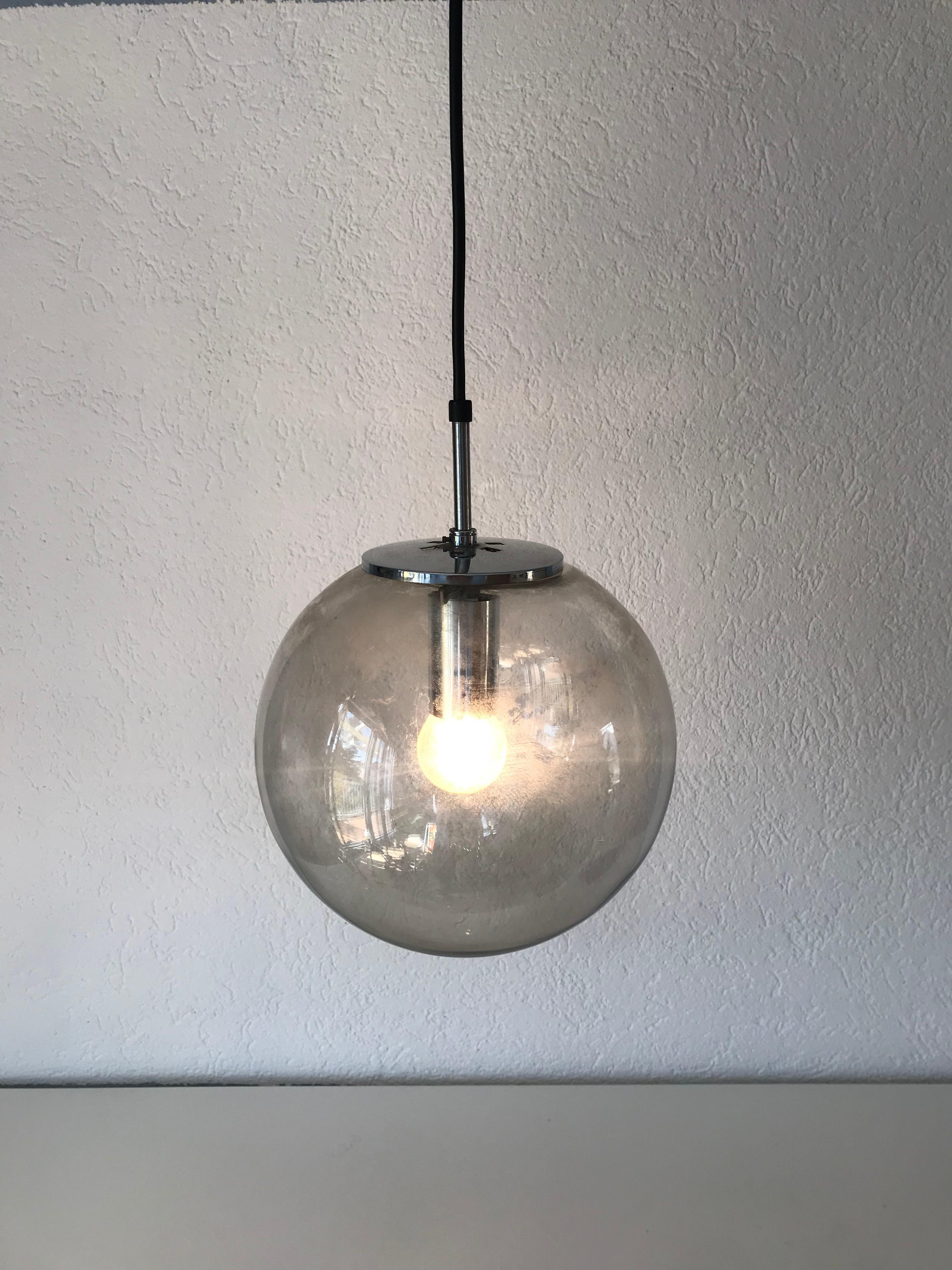Large pendant lamp by Glashütte Limburg made in the 1970s in Germany. Full glass ball with chrome metal top. Good vintage condition. 

The light requires one E27 light bulb.