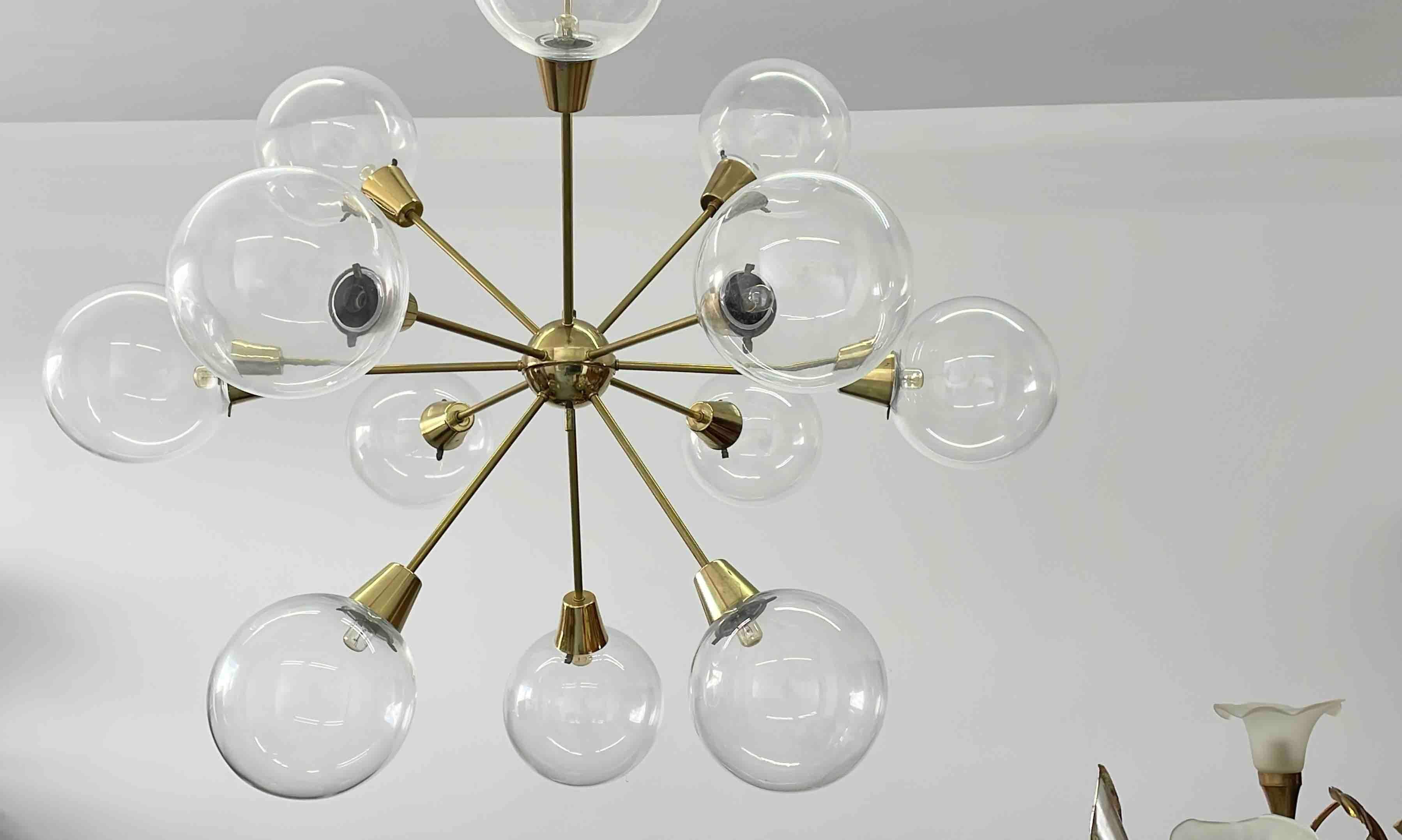 Beautiful and rare chandelier or pendant light by Kamenicky Senov. An original mid-century vintage piece manufactured around in the 1960s. It is made of brass and mouth blown large glass balls. Fixture requires twelve European E14 / 110 Volt