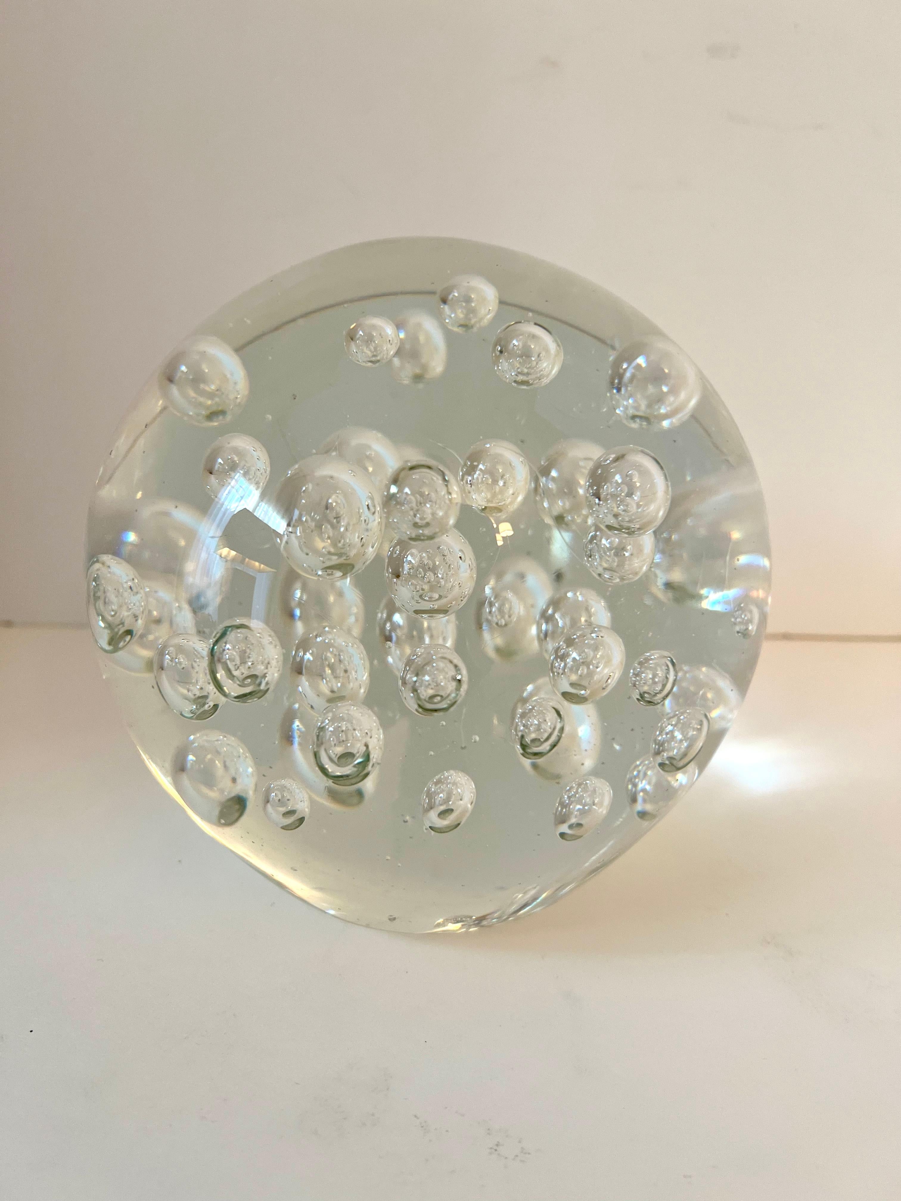 A Clear Glass Paperweight with bubbles.  Very large sphere that measure 5 7/8