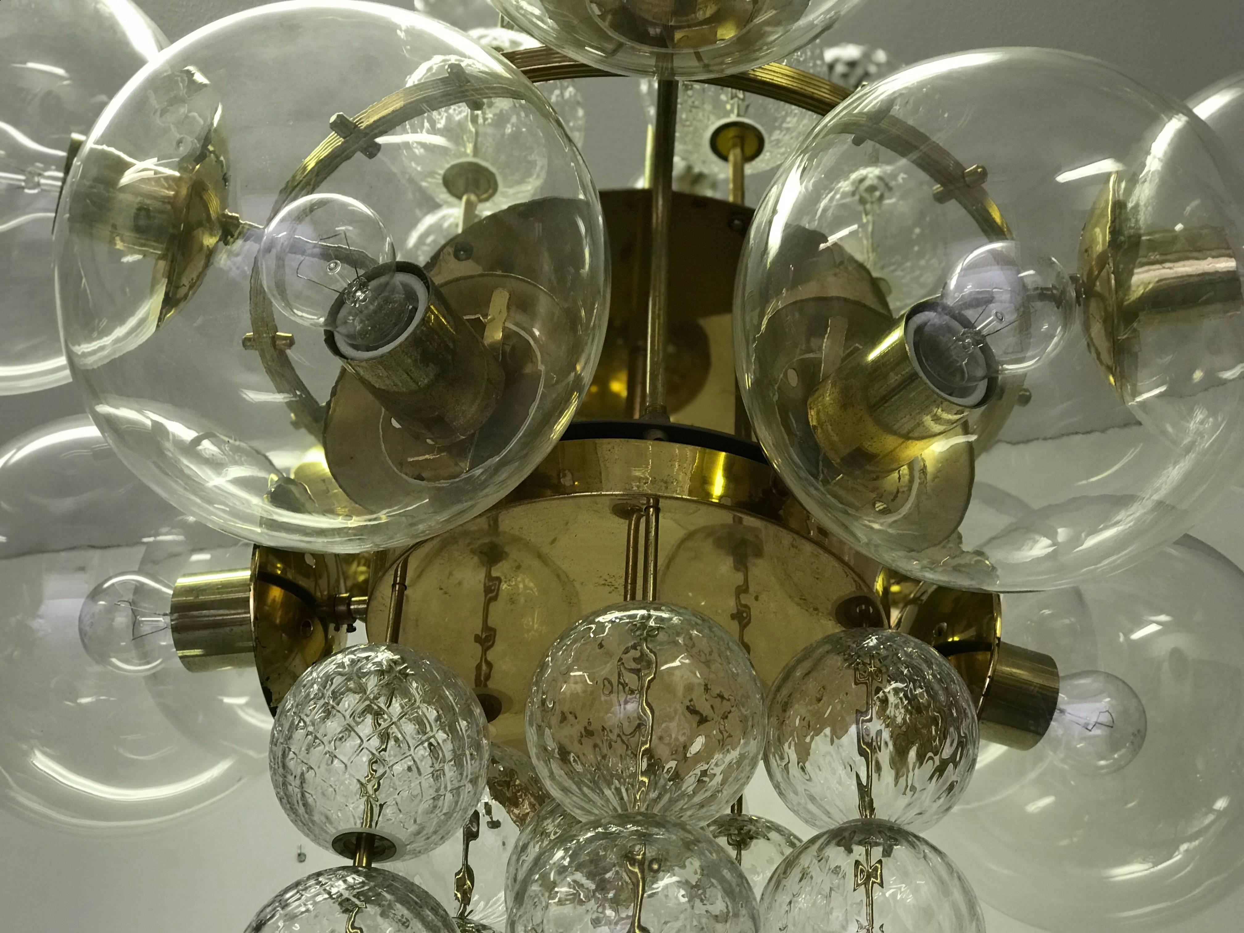 An unique chandelier from the 1965s. The brass construction is completed with the original patina. The glass balls are hand-blown. The conditions is very nice. The chandelier is fitted with ten glass spheres of 22 cm in diameter. Each arm has an