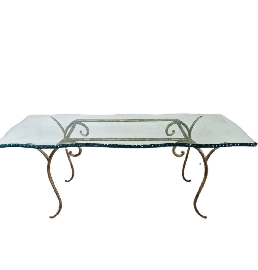 This Vintage Glass and Metal Console Table is a stylish and elegant piece of furniture, perfect for any indoor room. Made in Italy in the 1970/80s, this fully assembled console table features a rectangular tabletop of glass with a gold finish, set