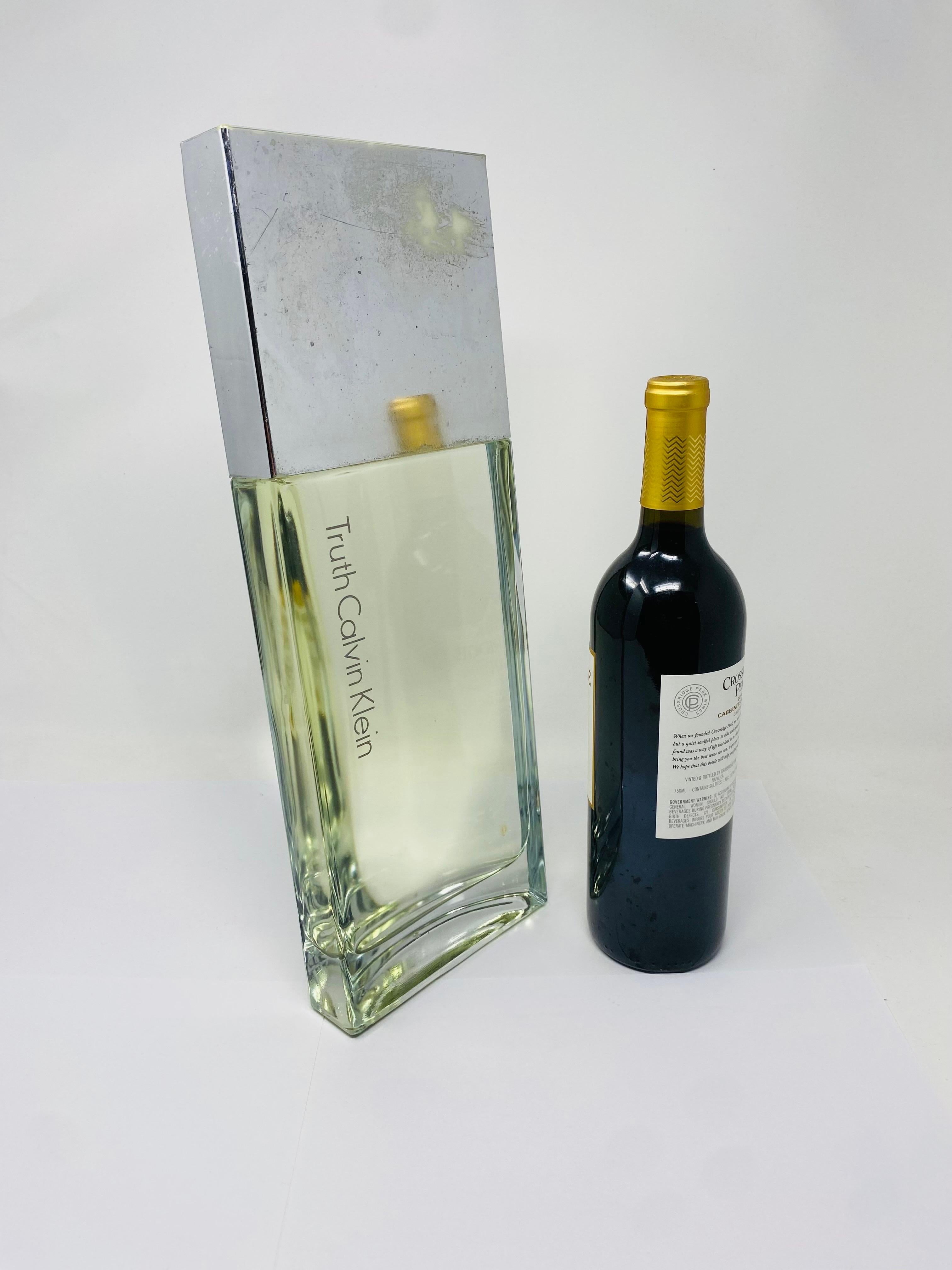 Incredibly large and iconic glass factice by Calvin Klein. This factice follows the iconic fragrance bottle legacy that is his fragrance Truth. The large scale of this piece is softened by the clean simple lines of the bottle design. Following the