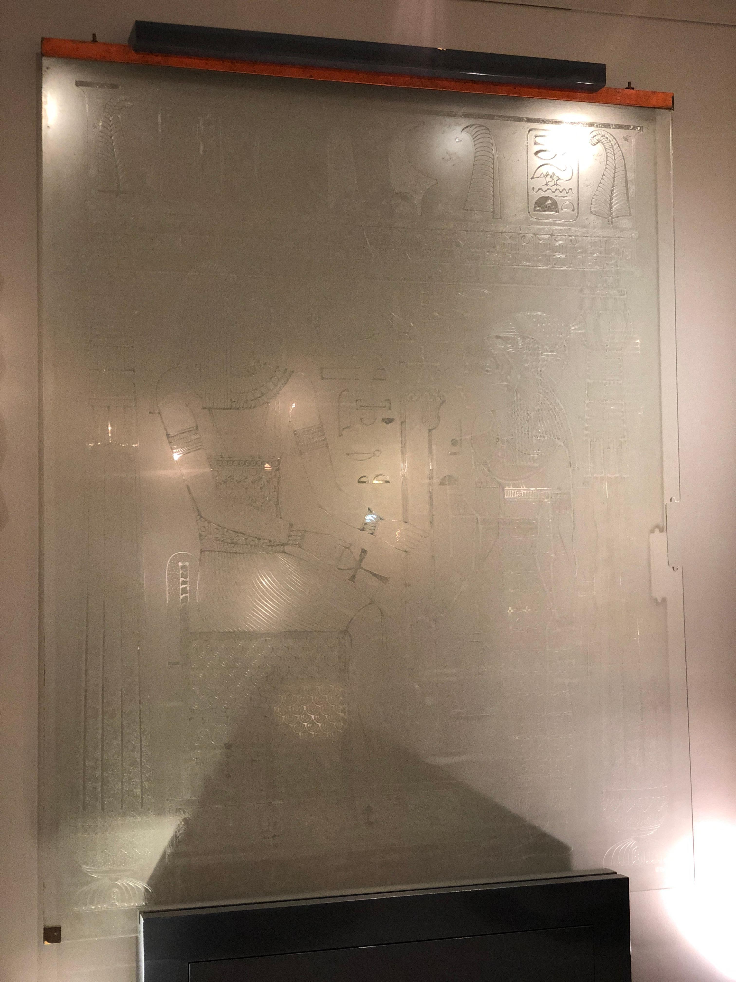 Etched glass, depicting a pharaoh and his queen surrounded by design motifs and hieroglyphics. Signed and dated in the glass. 

Originally used as a free hanging, sliding door.