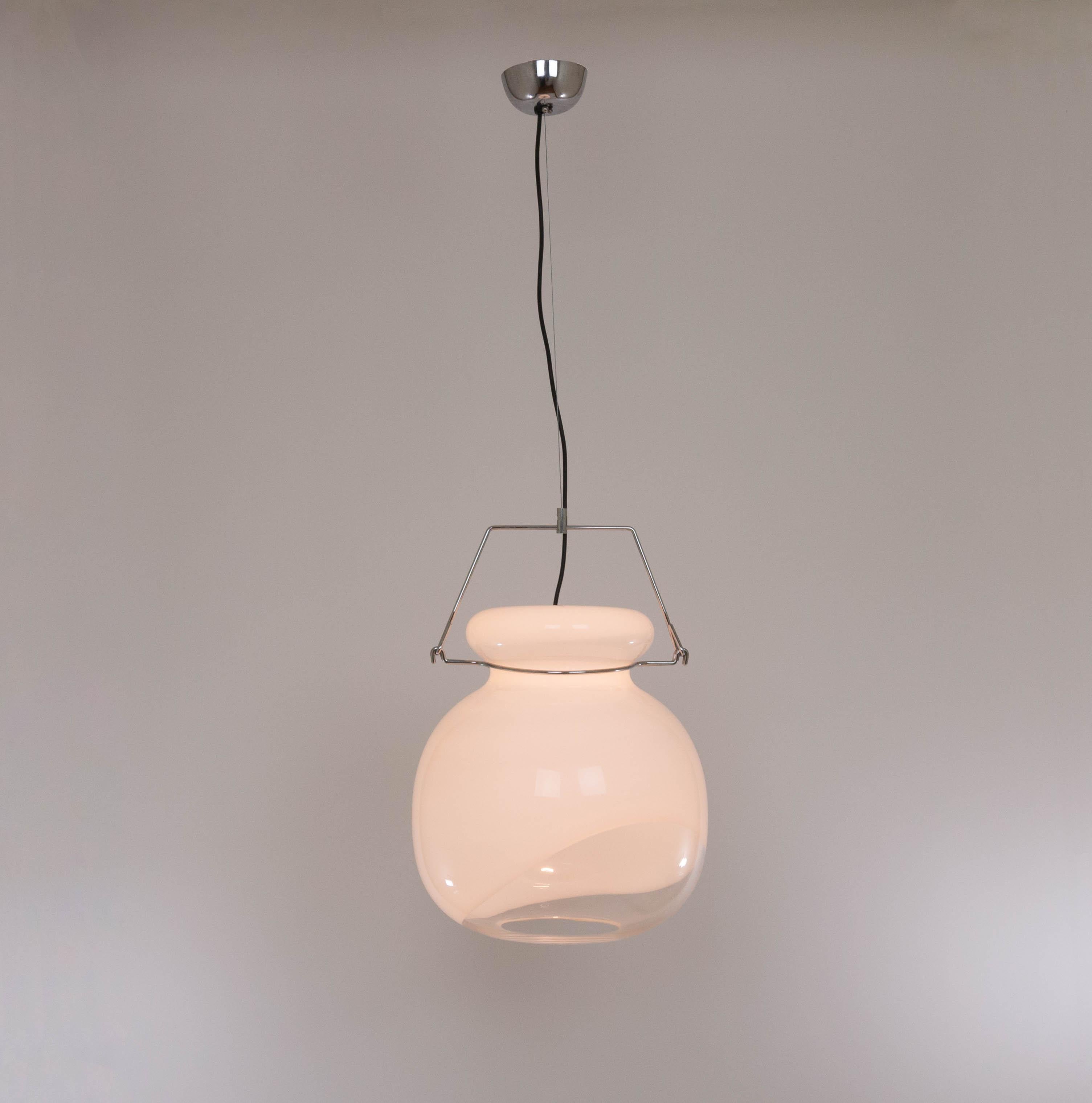 Large pendant designed by glass artist Toni Zuccheri and produced by VeArt in the 1970s

The lamp consists of a large Murano glass sphere, in a playful combination of white and transparent glass. The sphere is wider at the top of the glass in order