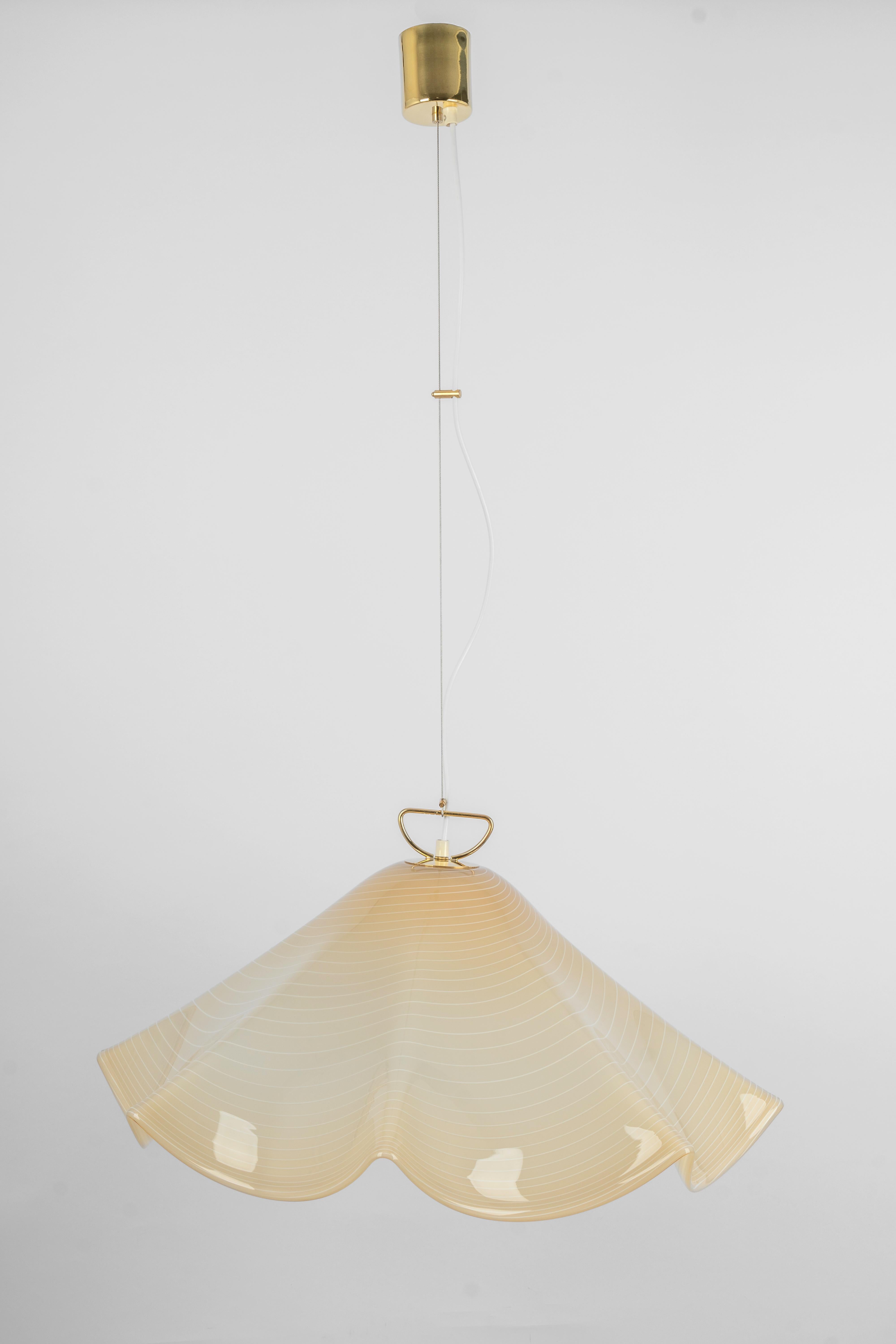 Stunning glass Pendant light by Kalmar  made in the 1970s
Nice structured glass, beautifully refracting the light.
High quality and in very good condition. Cleaned, well-wired and ready to use.
The fixture requires 1 x E27 standard bulb.
Light bulbs