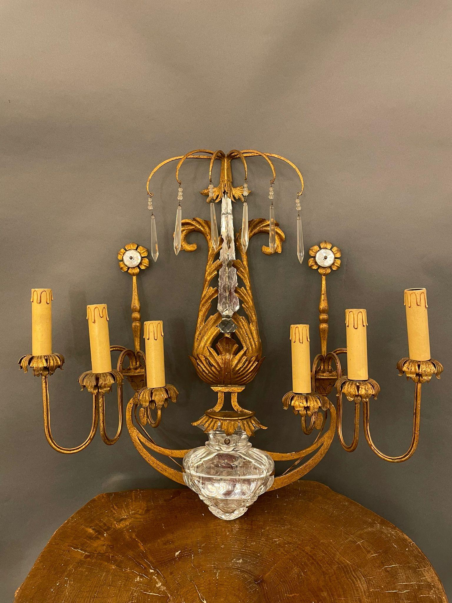 Highly decorative and beautiful 1940s French crystal   sconce attributed to Maison Baguès, six-light. Gilt gold finish
Iron and crystal

Good original vintage condition. Wear consistent with use and age.

