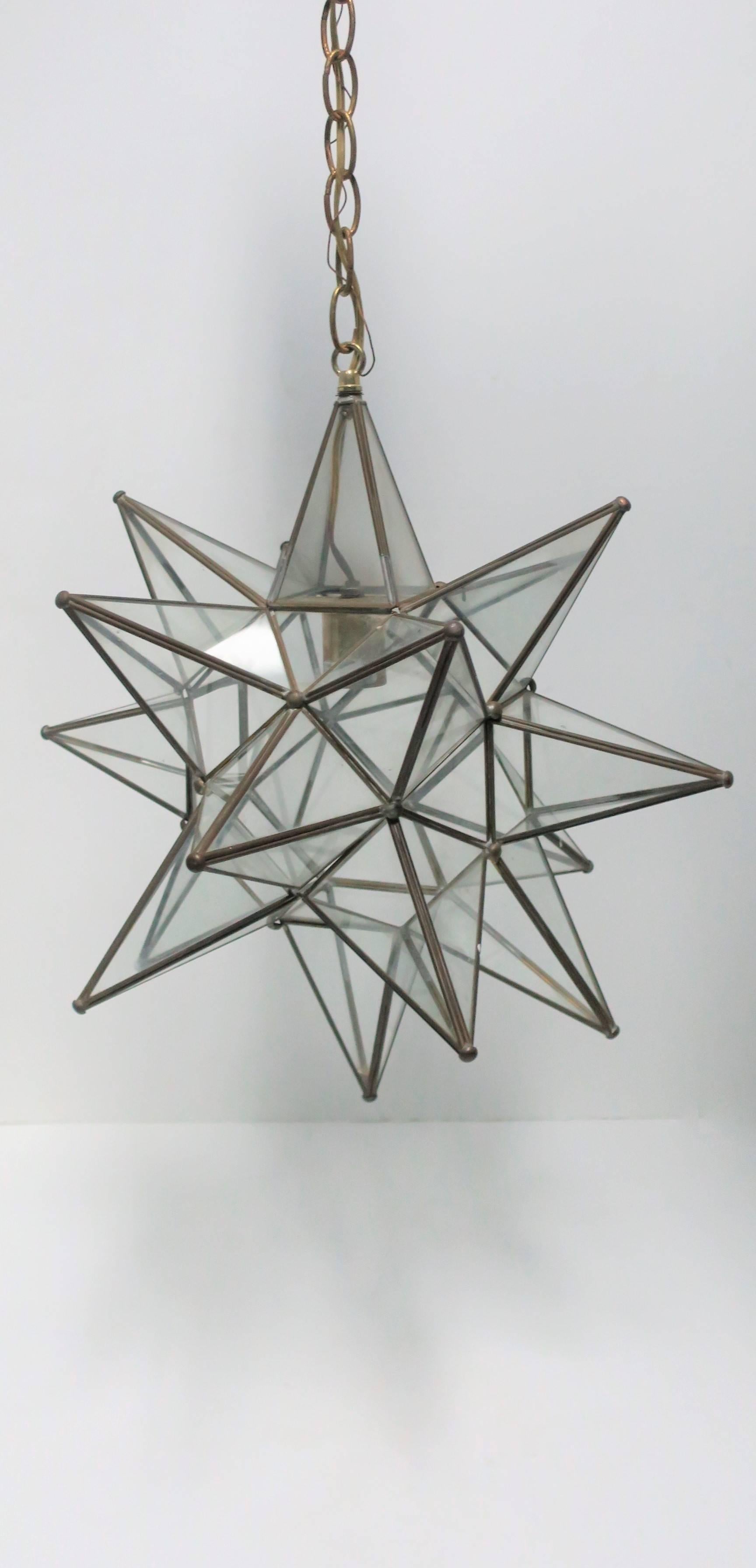 A beautiful vintage large geometric metal and glass star pendant light fixture. Piece has top-side access to inside lamp, please see image #11. 

Piece measures: 
'Star' is 19 inches in diameter
Length with chain is 36 inches. 

Item available