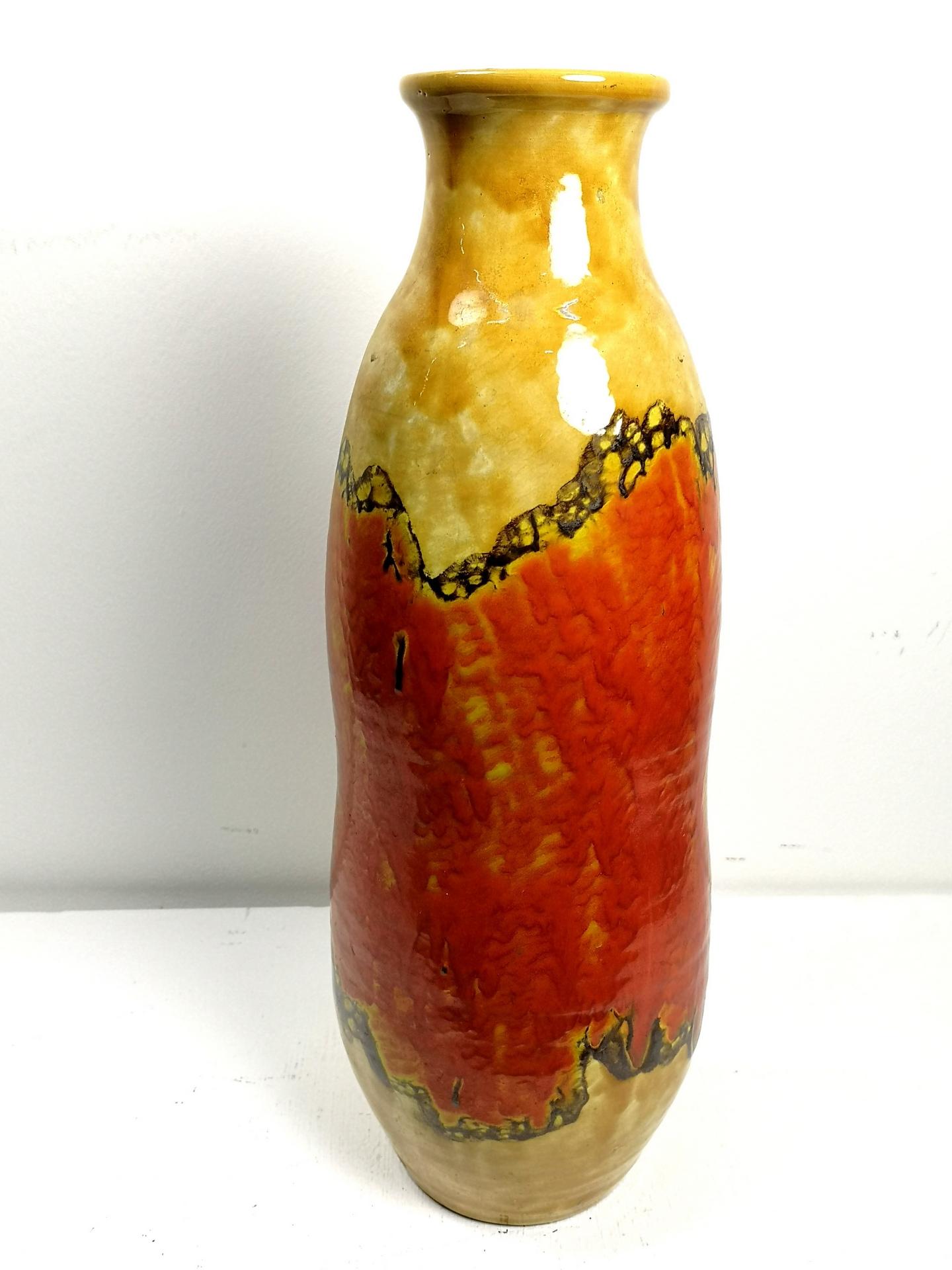 This large glossy glazed ceramic floor vase is a hand-made piece, from the 1970s artisan era. It's in great condition but there are minor chips of the glaze at the bottom.