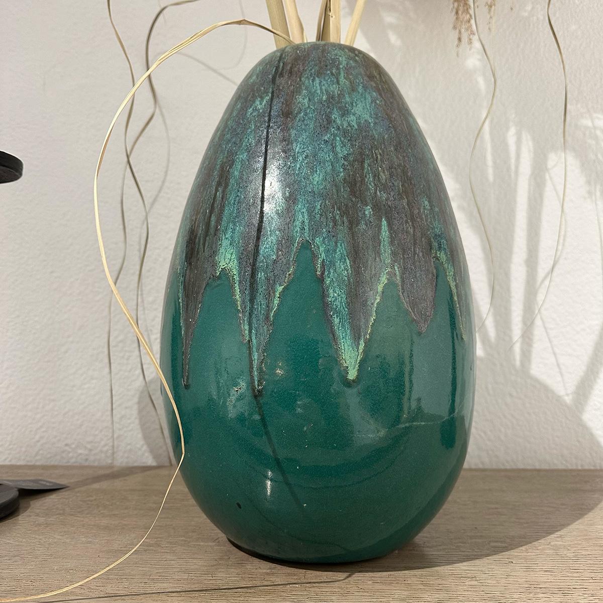 A large glazed ceramic green vase by Atelier Primavera, hailing from the 1950s, is a masterpiece that epitomizes mid-century ceramic artistry. Crafted by the prestigious Atelier Primavera, a renowned French workshop that played a pivotal role in