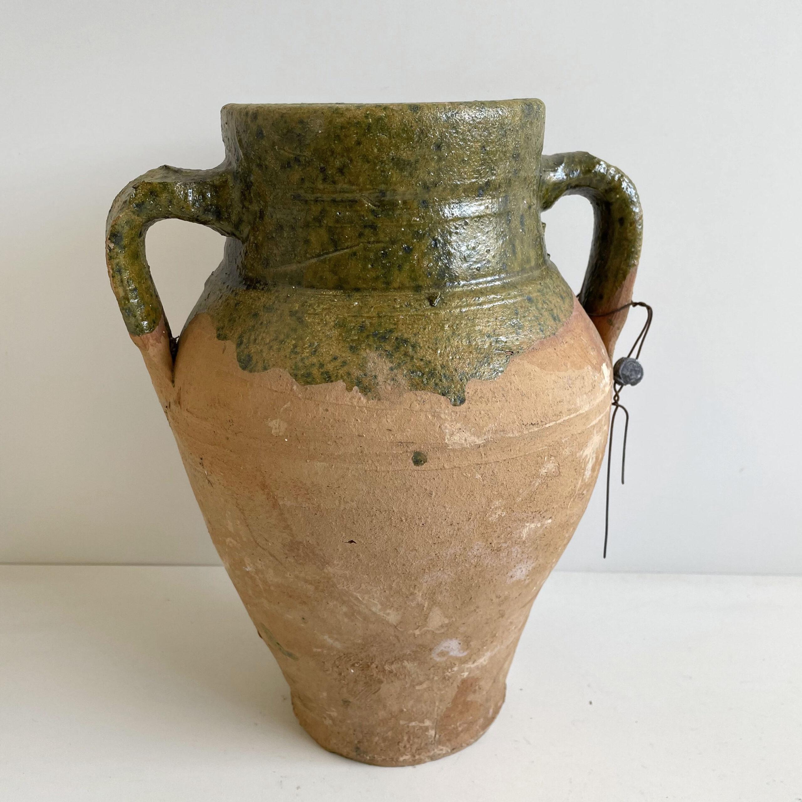 Beautiful clay pottery with dark olive green dripping glaze.
Imported.
Measures: 11” H x 9”W x 7”D