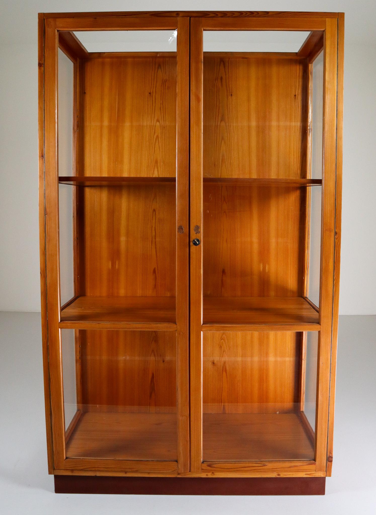 Large glazed display cabinet with perfect patina and original glass made in Praque Czech Republic 1950s for the National U P Museum Praha in solid Pine .The wooden shelves can be height adjusted. Pieces like this with original patina and glass are