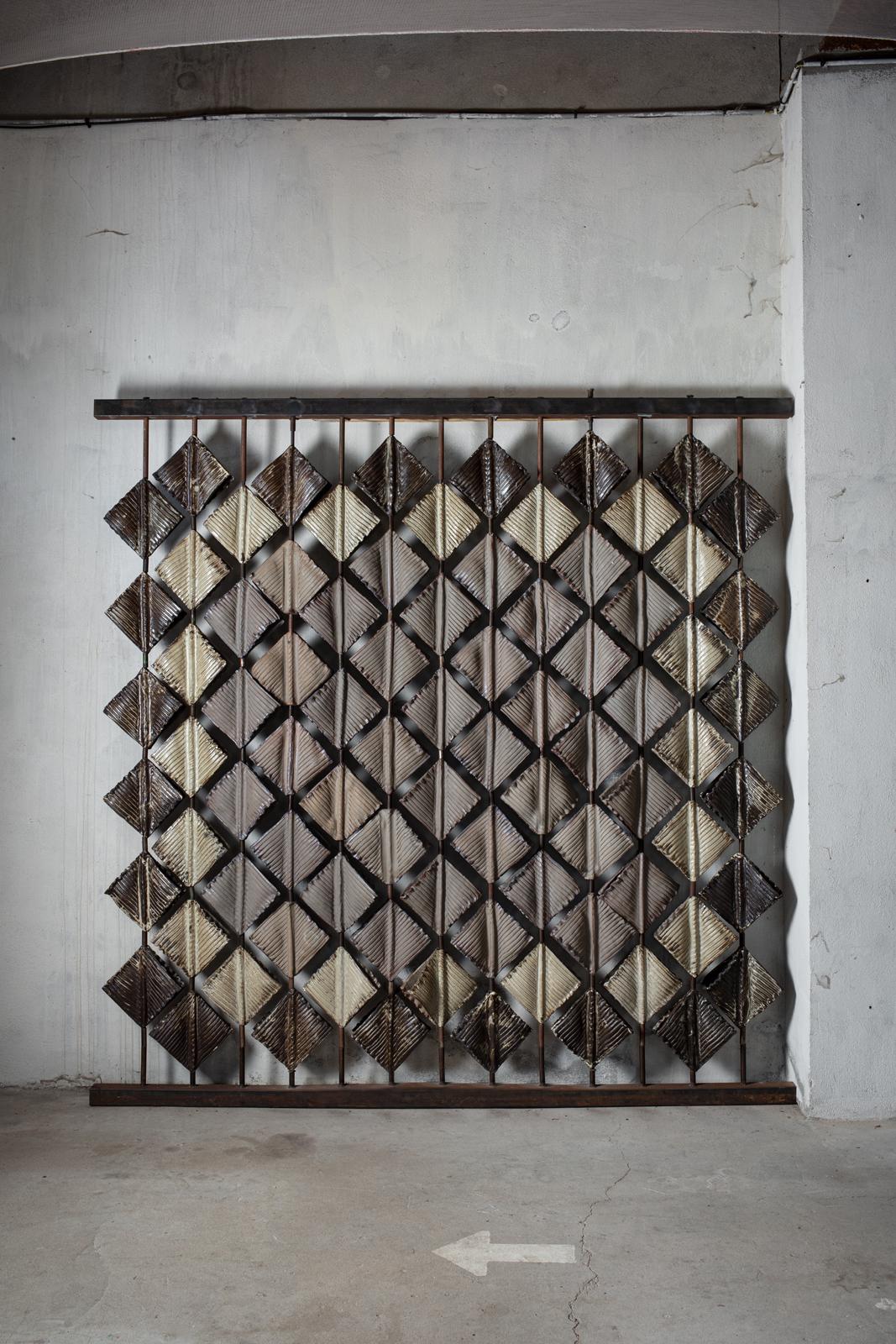 Large glazed stoneware screen composed of 84 modular elements by Anne Barrès. 
2010. 
Unique piece. 
Can be displayed both indoors and outdoors.
H : 95.5’ x 93.7’ inches (claustra).
H : 10.6’ x 10.2’ x 3.3’ inches (each item).
Approximate