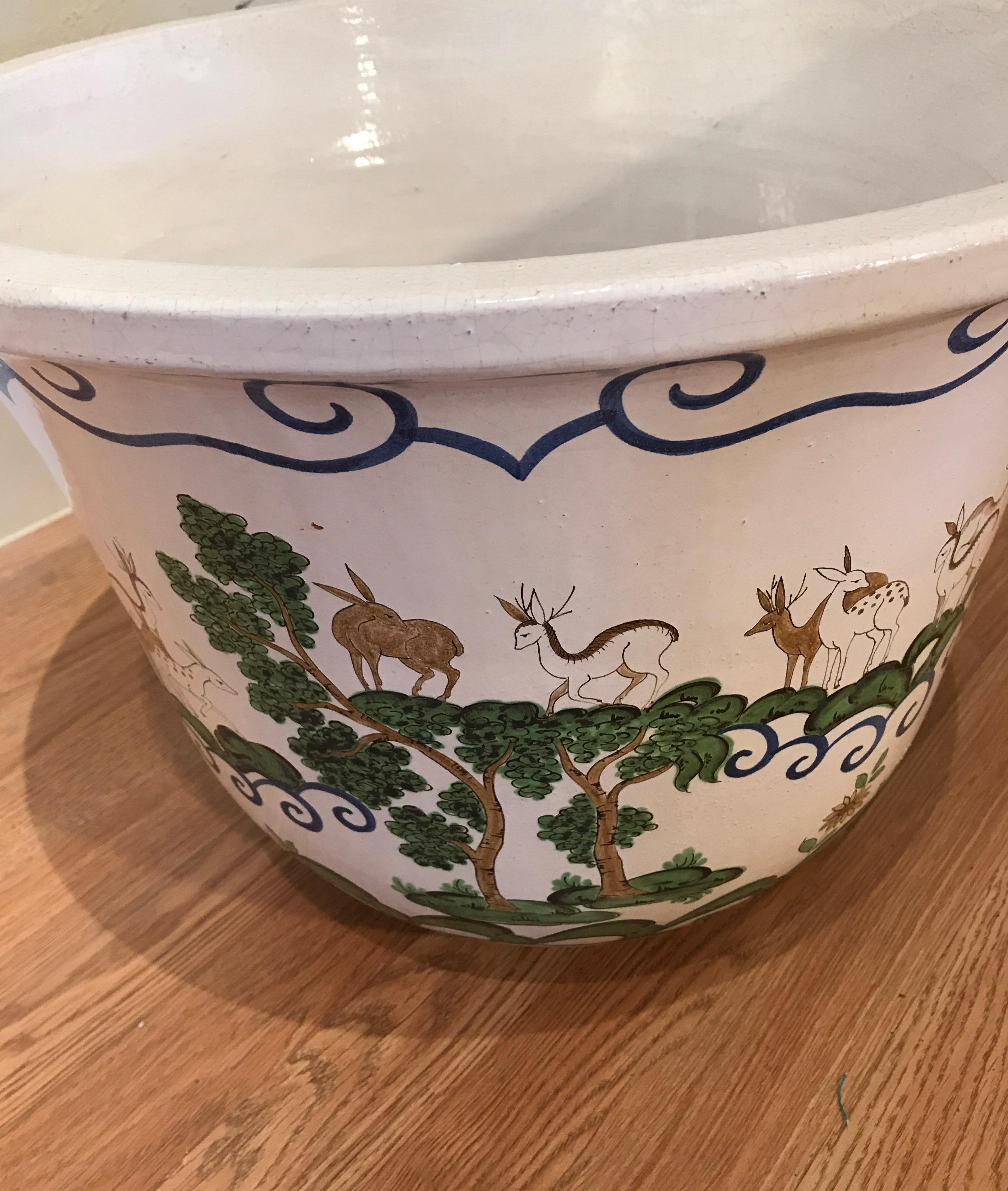 Large faience Jardinière with beautifully painted scenes of deer and antelope on white background.