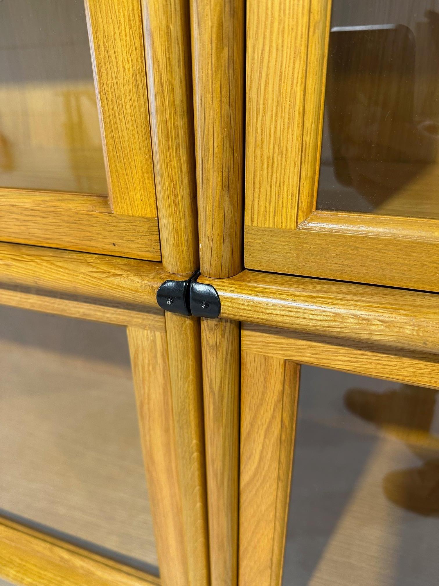 New solid oak Globe Wernicke stackable bookcase. 
Back and bottom are not solid as this is always the case with every Globe Wernicke Bookcase
Arranged in 4 rows of 6 sections with a plinth and top. 
Size: 344cm x 35cm x h.261cm
Drawers are