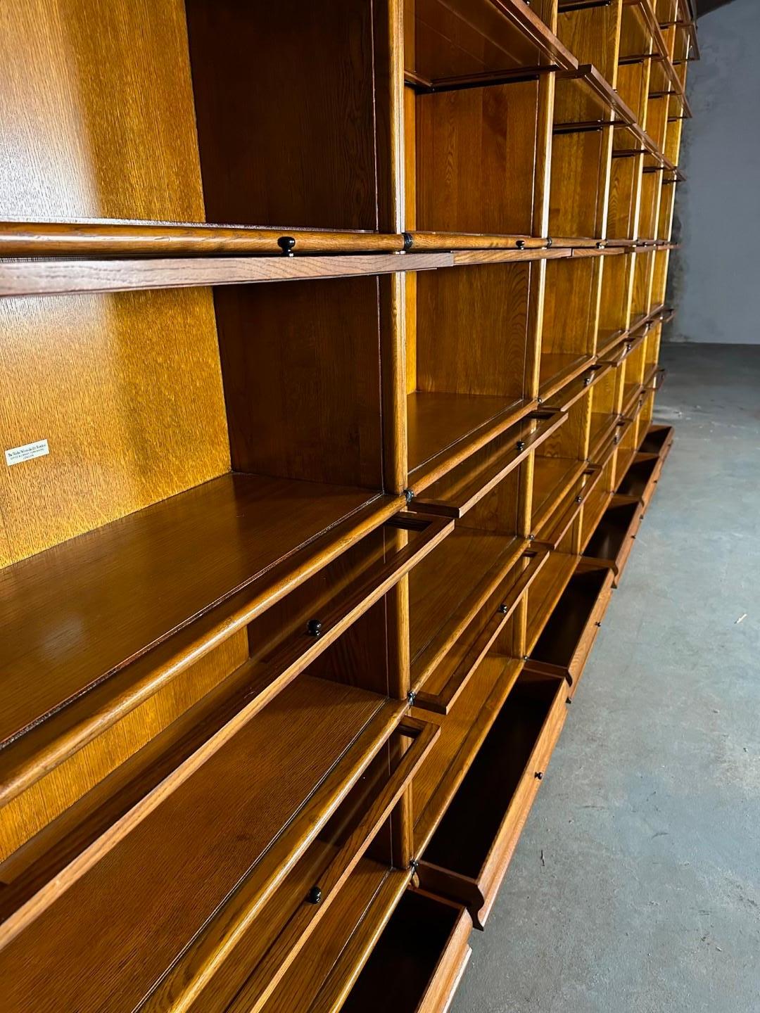 Large solid oak Globe Wernicke bookcase consisting of 36 stackable parts.  
Bottoms and back are from plywood like all Globe Wernicke Bookcases
Drawers in the base. Completely in perfect condition.


Size: 516cm x 35cm x h.250cm

