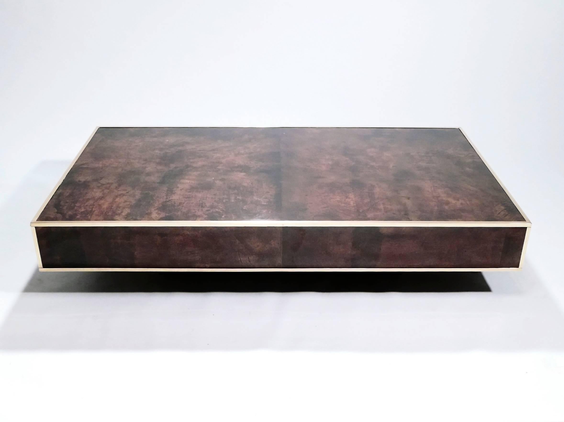 The varnished goatskin parchment, in rich shades of brown, makes this coffee table typical of designer Aldo Tura. This extra large piece would make a fascinating centerpiece for a living room. It’s been beautifully finished for a smooth, glossy