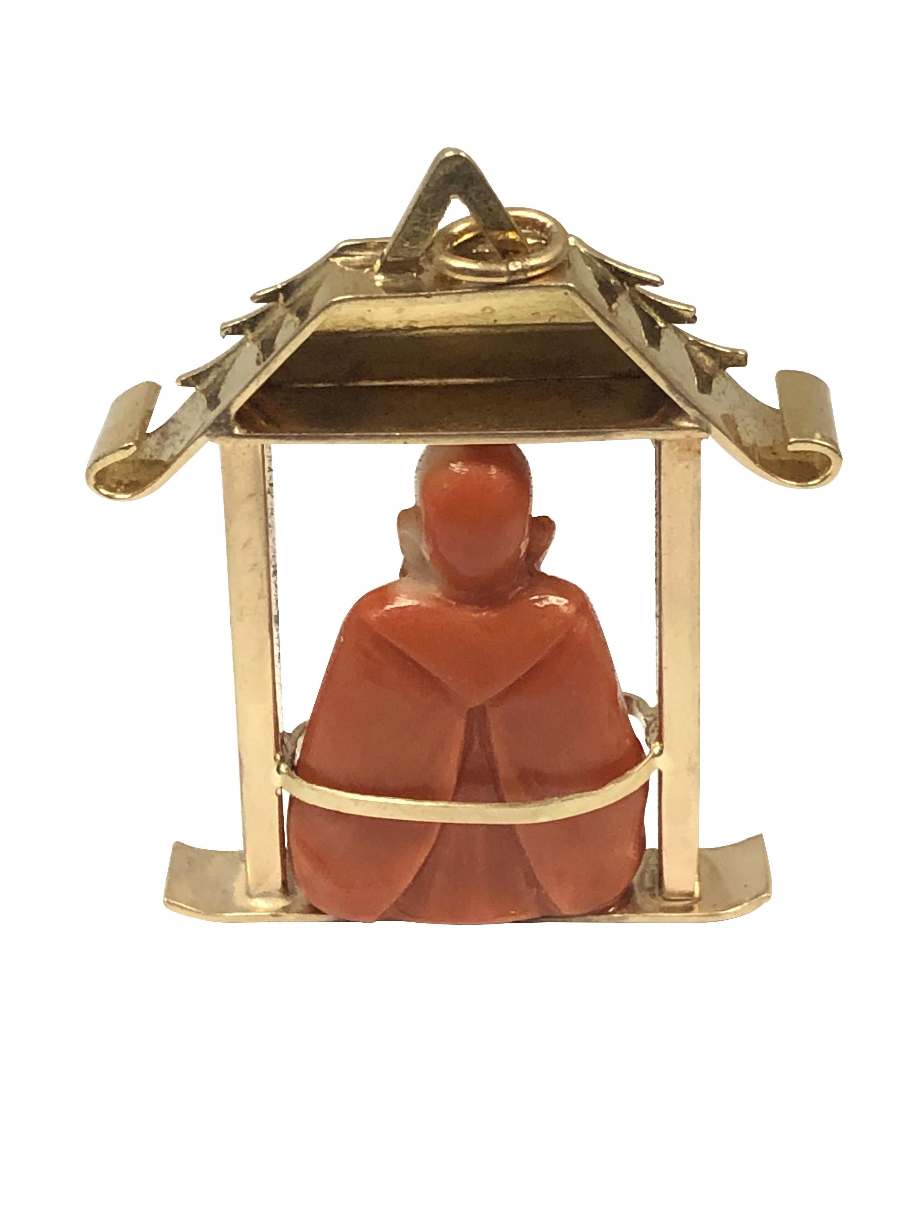Circa 1940s 14k Yellow Gold Pagoda form Charm Pendant, measuring 1 3/4 inches in length X 1 1/2 inches and weighing 22.7 grams. The center featuring a finely detailed carved Coral Confucius figure. 