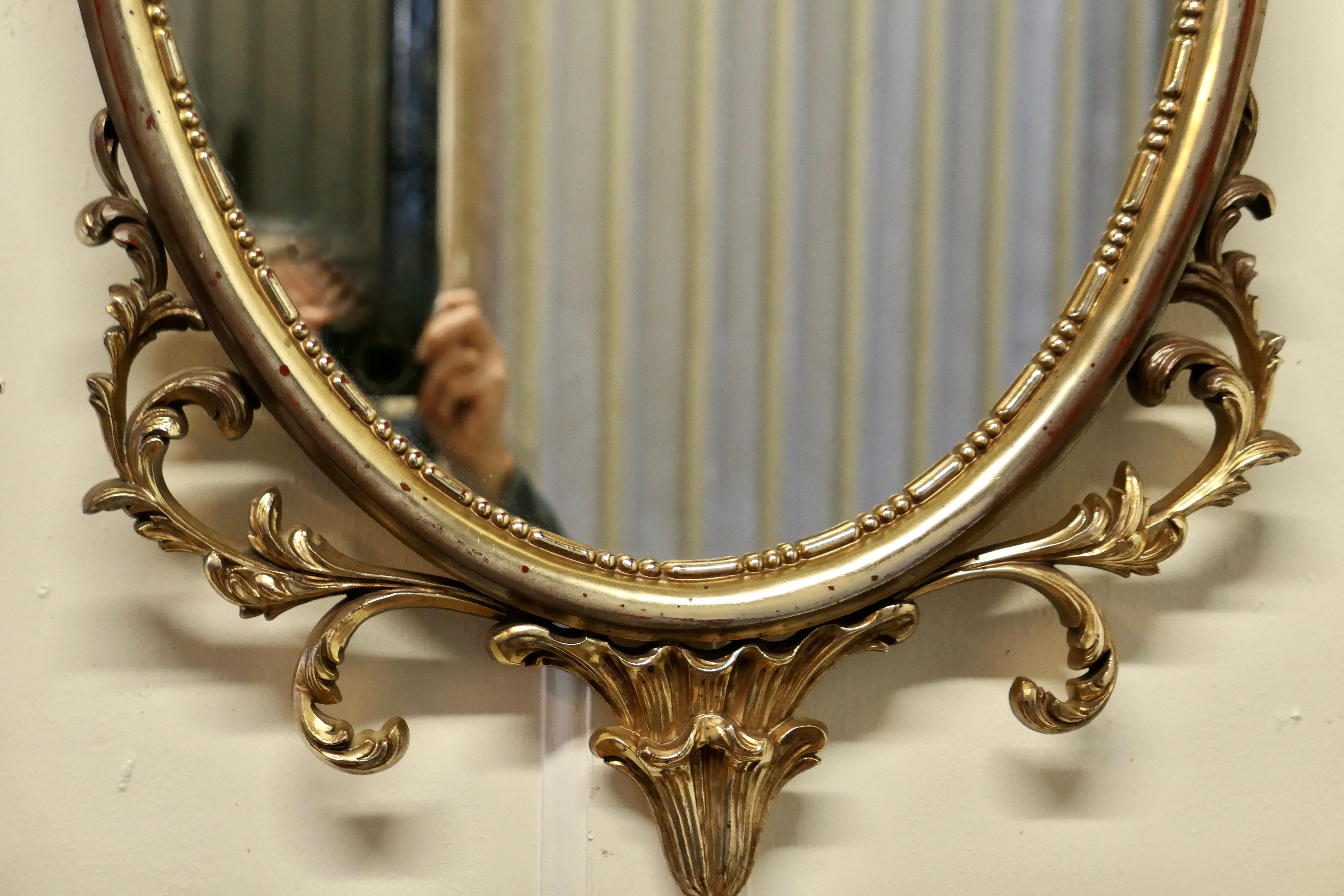 20th Century Large Gold Crested Rococo Style Oval Wall Mirror  For Sale