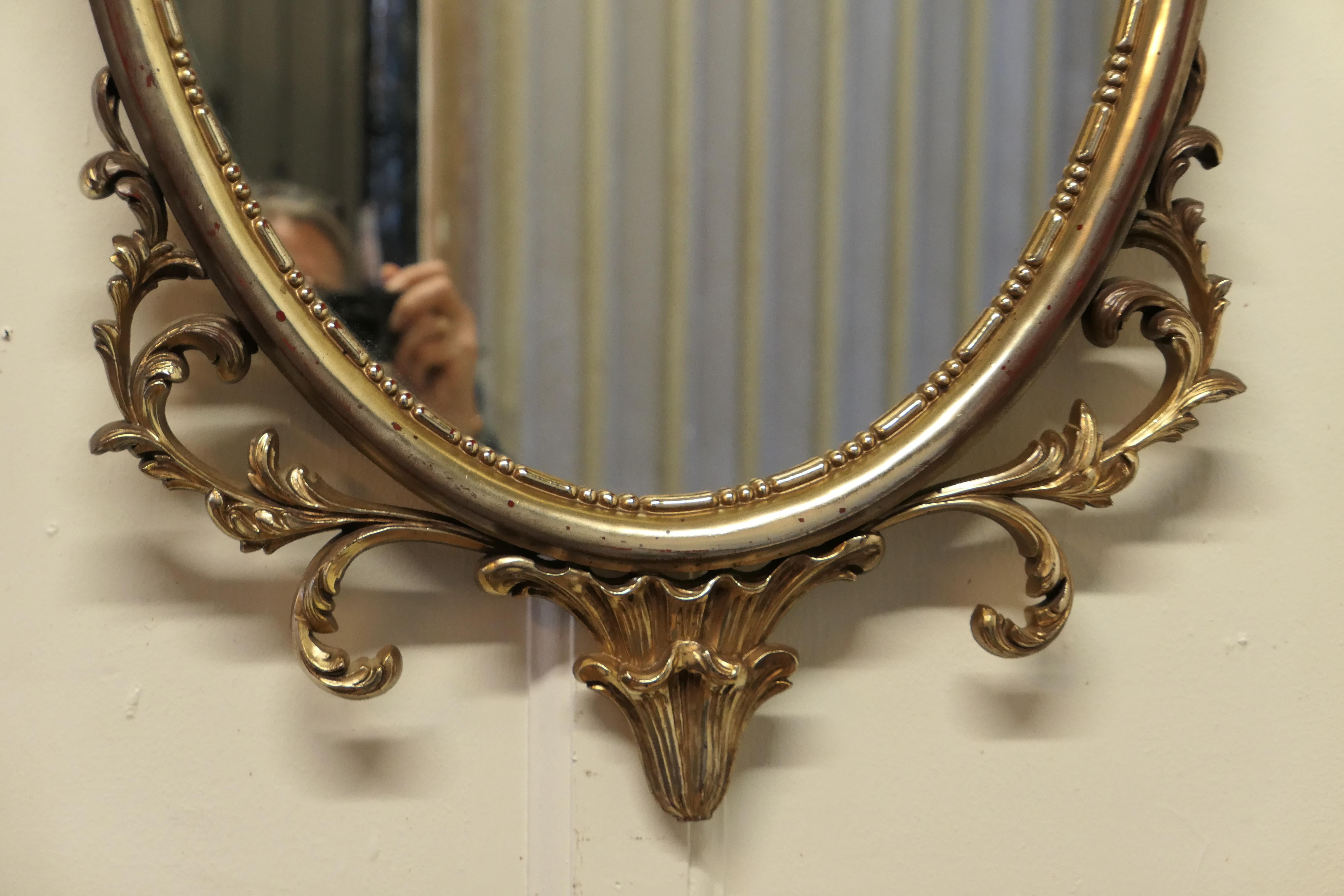 Composition Large Gold Crested Rococo Style Oval Wall Mirror  For Sale