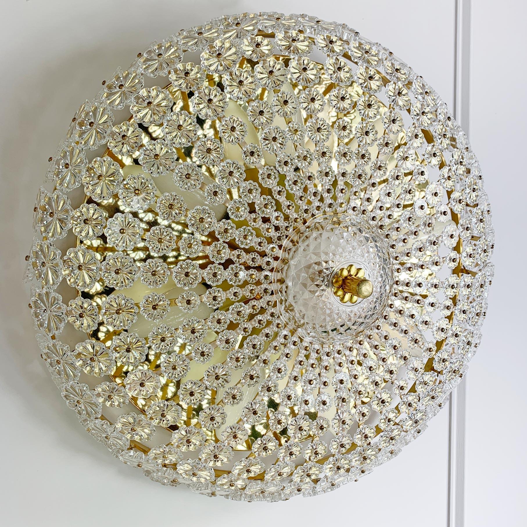 Emil Stejnar (Austria) sunburst flushmount light, designed for the H. Richter company 1950’s.
Very elegant large flushmount with hundreds of individual small glass reverse cut flowers on a brass frame, with a central cut glass cup.

The light