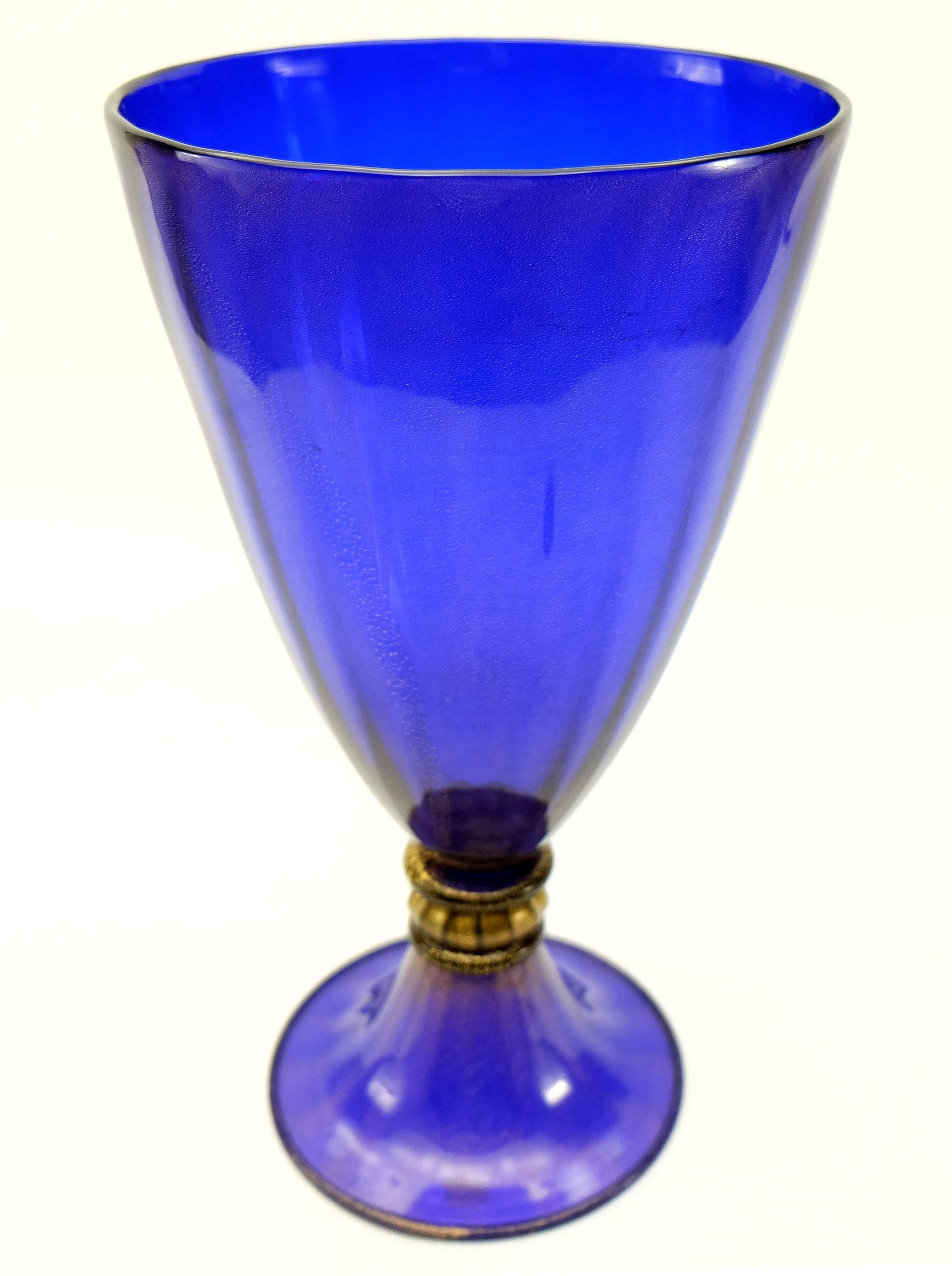 Murano Glass Gold-Infused Vase by Gabbiani Venezia, Italy

Offered for sale is a gold-infused cobalt blue Murano glass vase by Gabbiani. The gold-infusion is found throughout the blue as well as in the transparent accent detail near the base.
This
