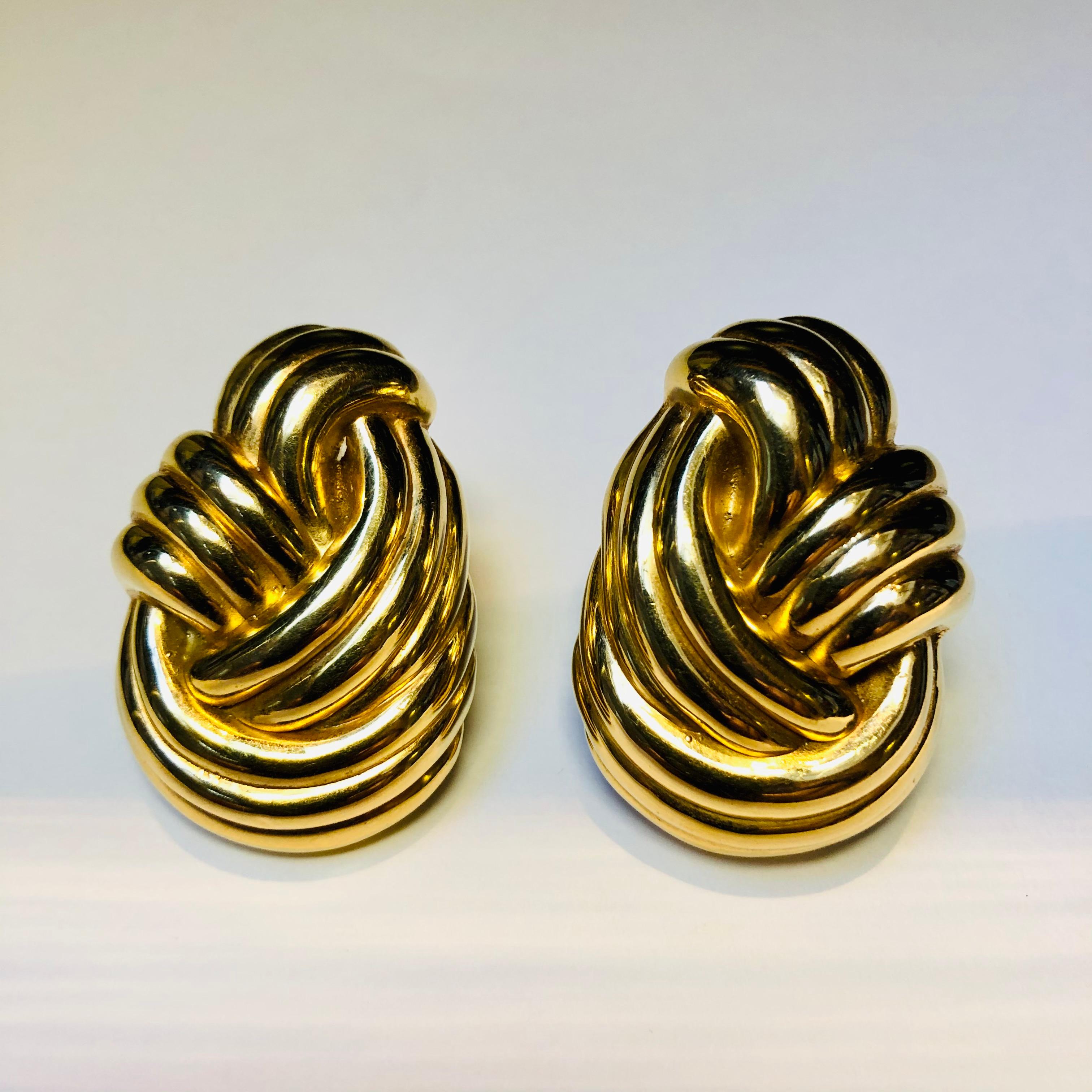 Large gold knot earring in 18 carat yellow gold with post and clip fittings (French clips). Offering a distinctly 1980’s and contemporary take on grown up glamour. These earrings have a weighty look but are light and wearable for all day and night